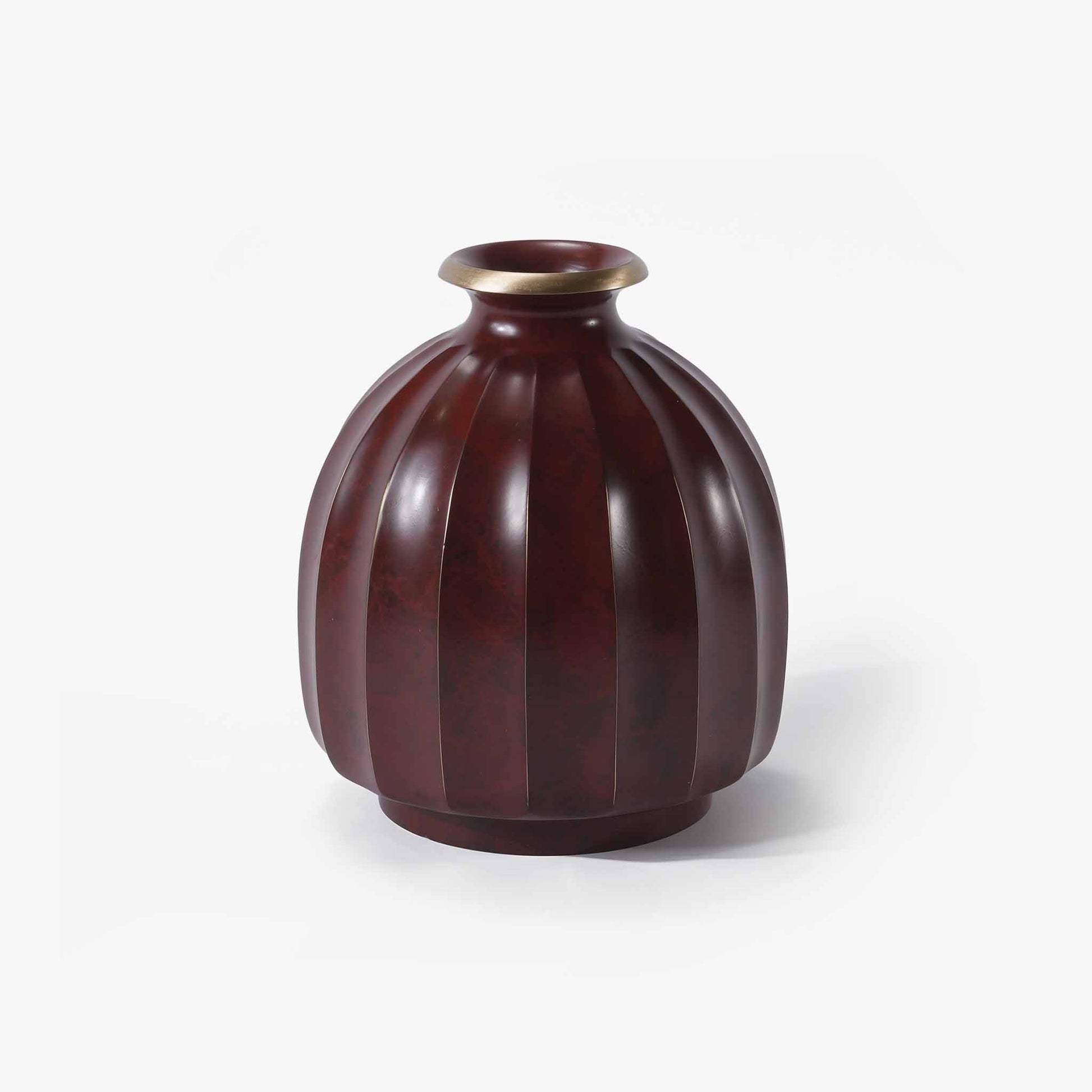 Striking red brass lantern vase symbolizing warmth and timeless elegance.