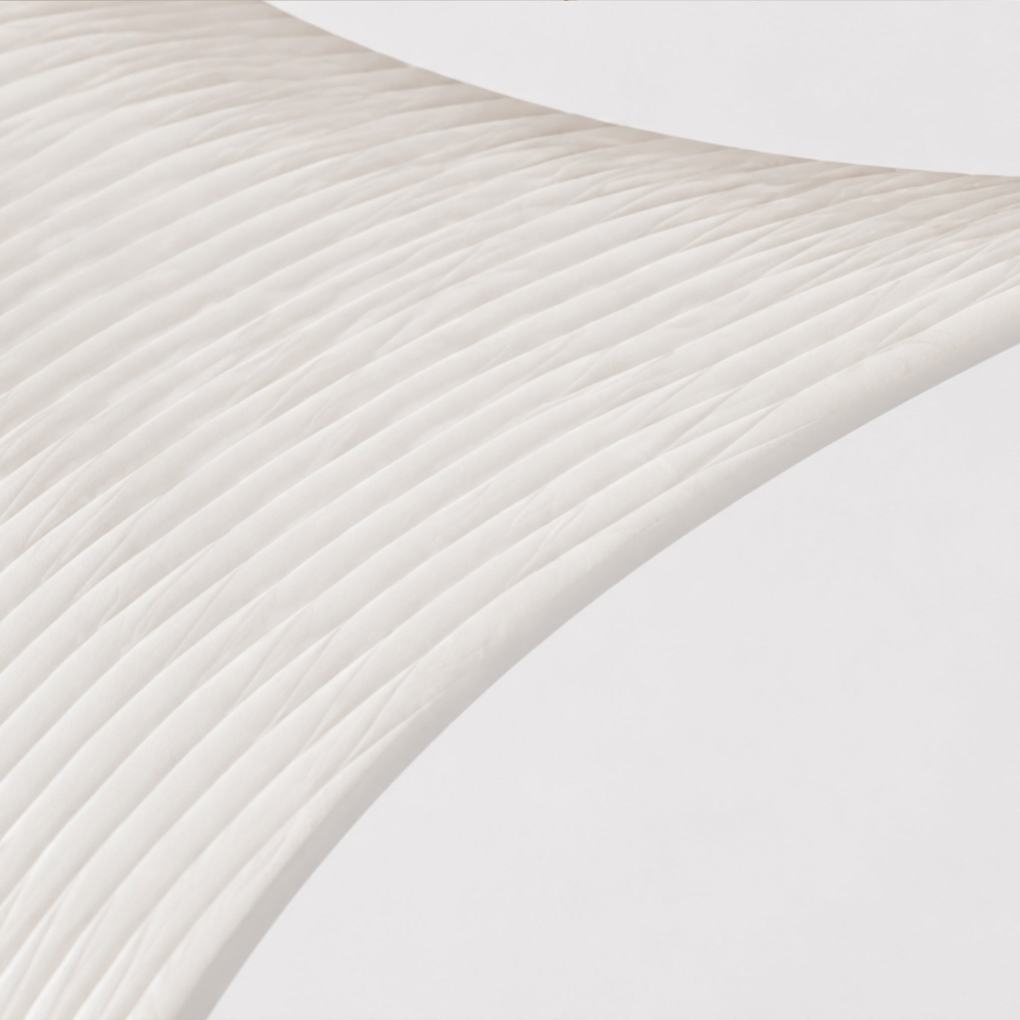 Close-up of the BUTTERFLY side cabinet showing the clear acrylic surface and expandable honeycomb paper structure.