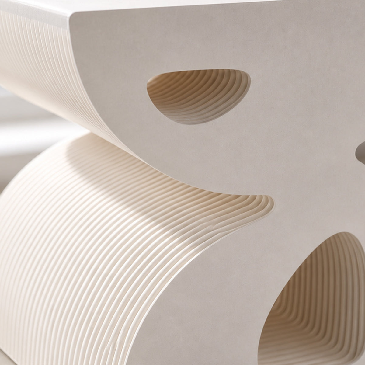 Close-up of the BUTTERFLY side cabinet showing its curved white panels and layered honeycomb kraft paper structure.