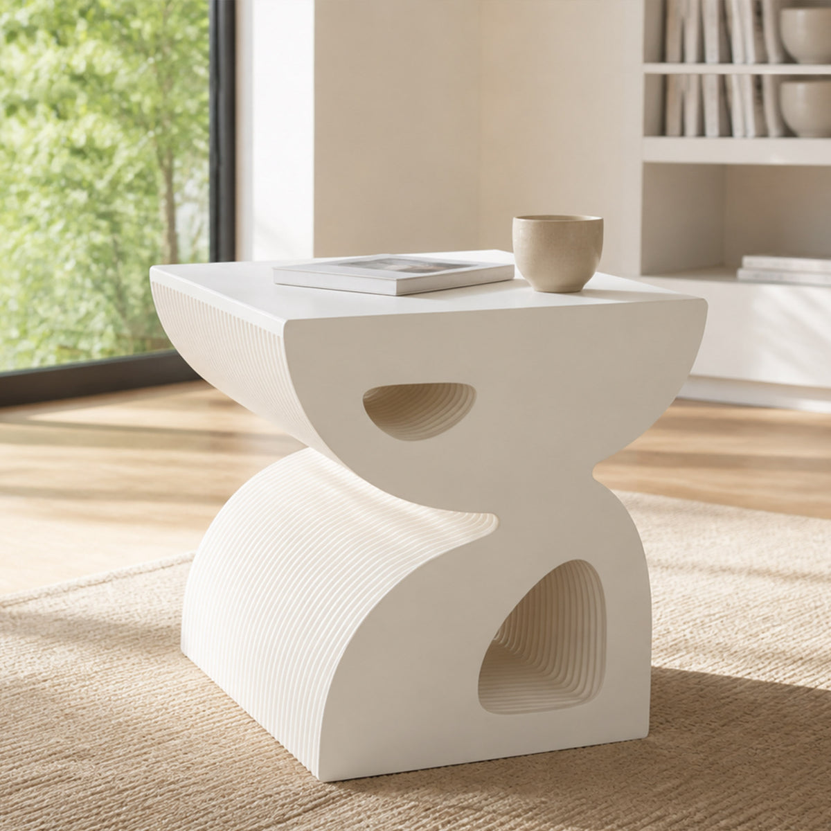 Small white BUTTERFLY foldable side table with an acrylic top, styled with a book and ceramic cup beside a bright window.