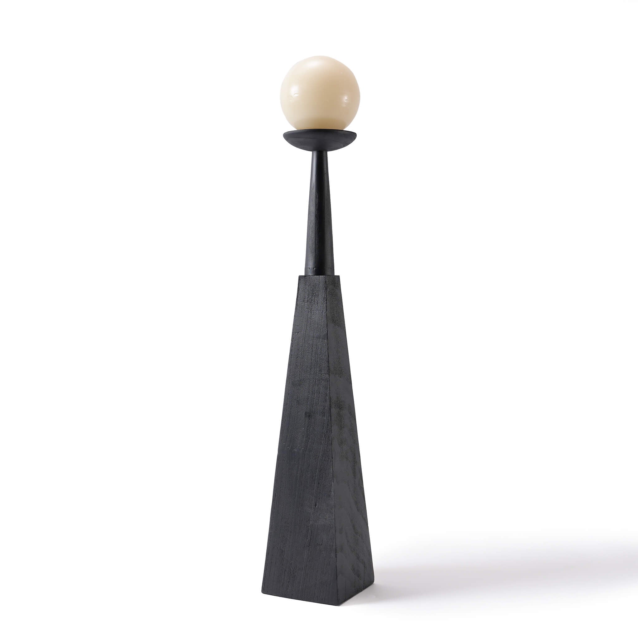 Single tall carbonized wood floor candle holder featuring a geometric base and spherical candle