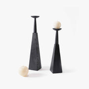 Set of two geometric black wood floor candle holders in varying heights with beige candles