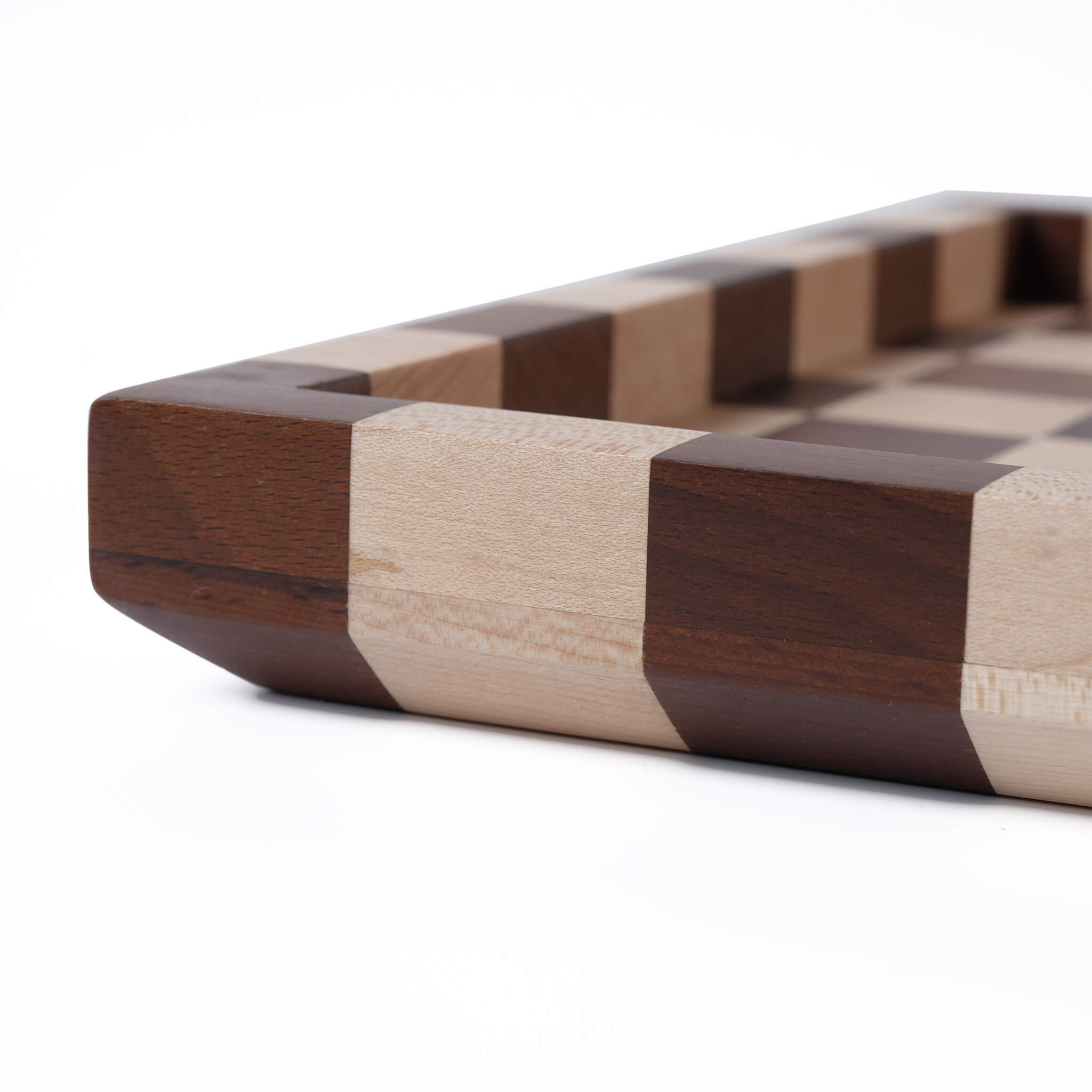 Side profile highlighting the rich contrast between the dark walnut and light maple materials