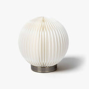 Premium spherical kraft paper desk lamp with an accordion honeycomb shade for minimalist modern living spaces.