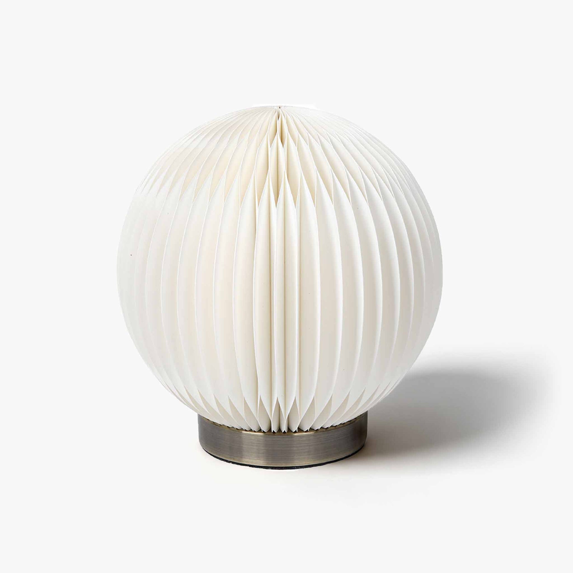 Premium spherical kraft paper desk lamp with an accordion honeycomb shade for minimalist modern living spaces.