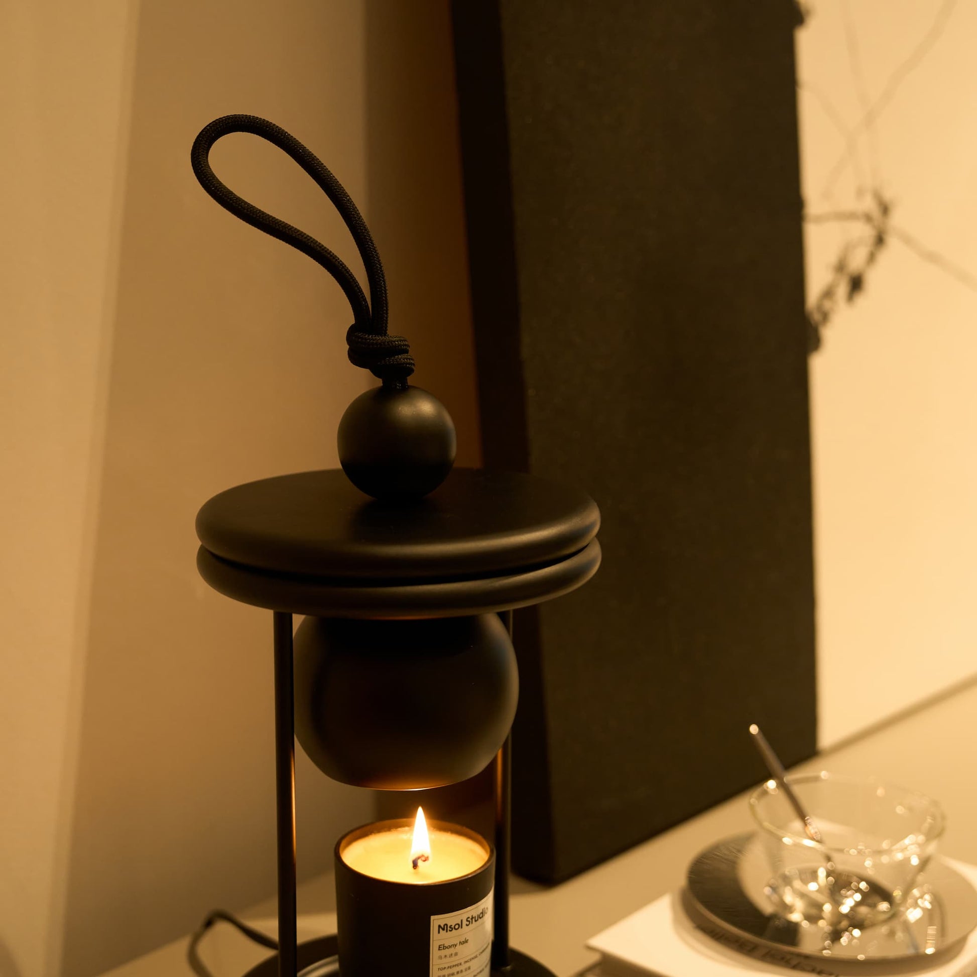 Warm ambient light radiating from the GU10 halogen bulbs of the Dawn flameless wax melter.