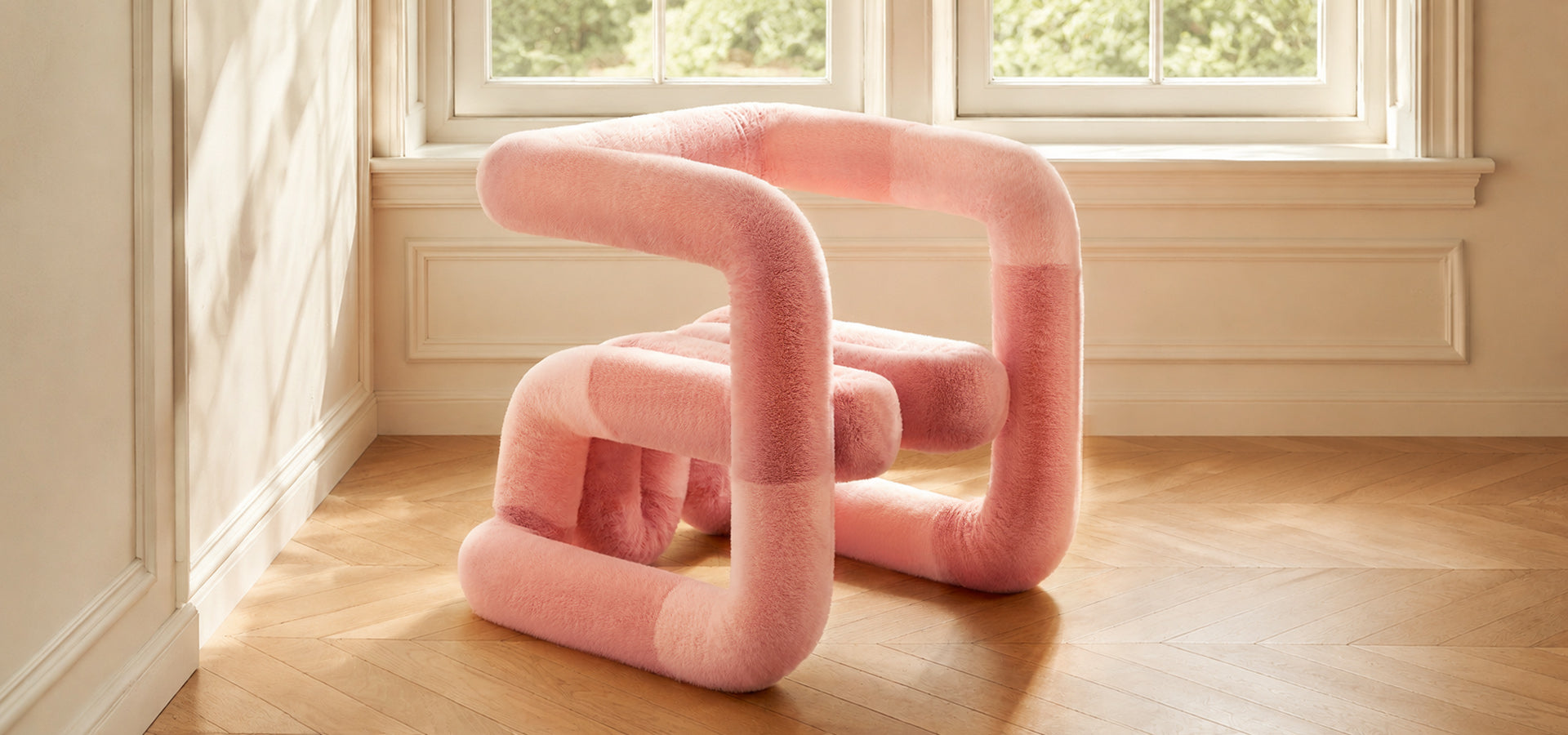 Pink sculptural faux-fur lounge chair in a sunlit contemporary interior from the Artamore designer furniture collection.