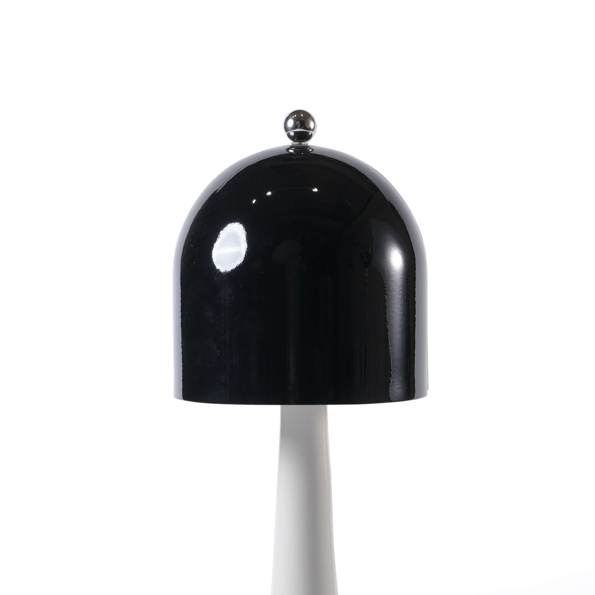 Close-up of the spherical metal touch switch atop the black lampshade of the rechargeable modern desk lamp