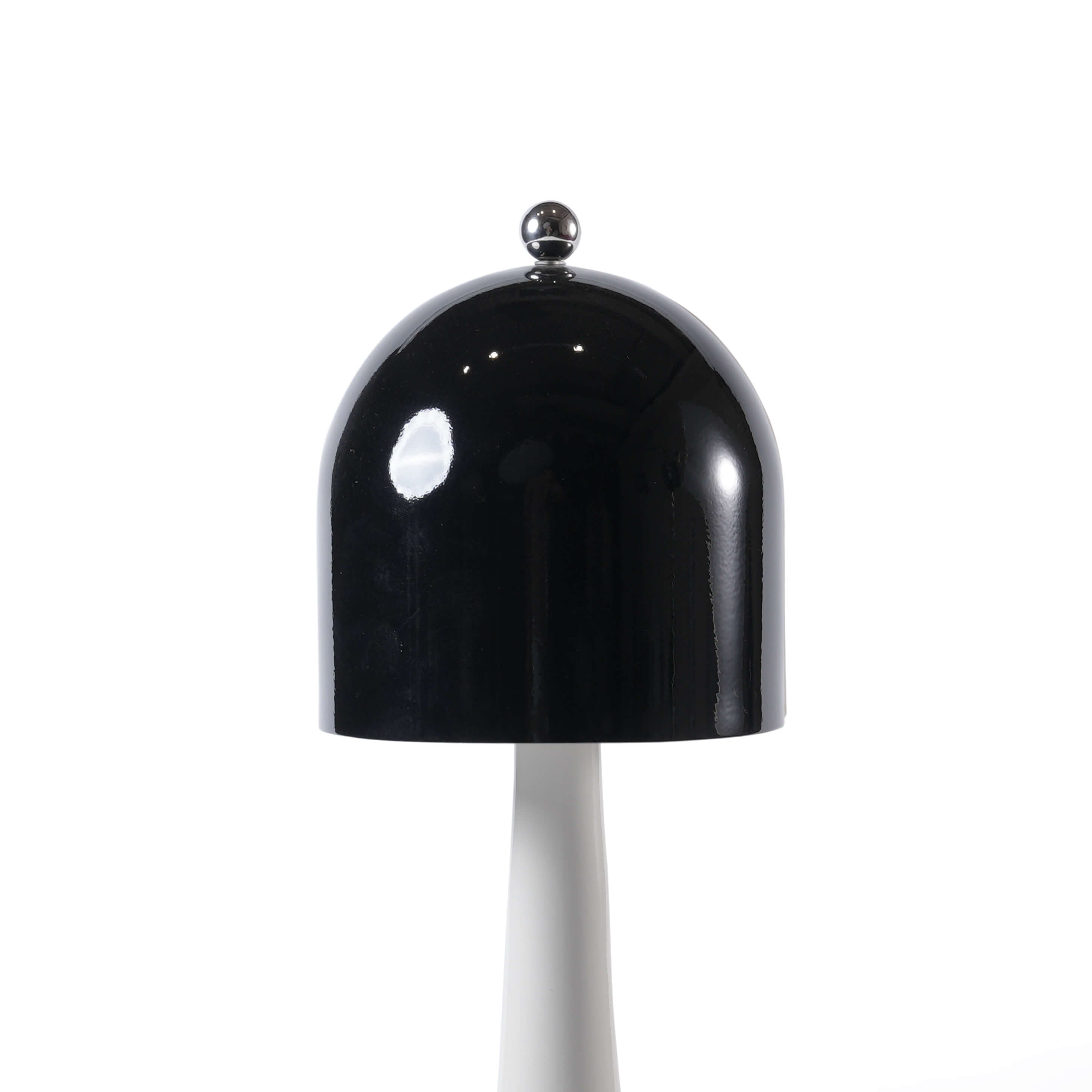 Close-up of the spherical metal touch switch atop the black lampshade of the rechargeable modern desk lamp