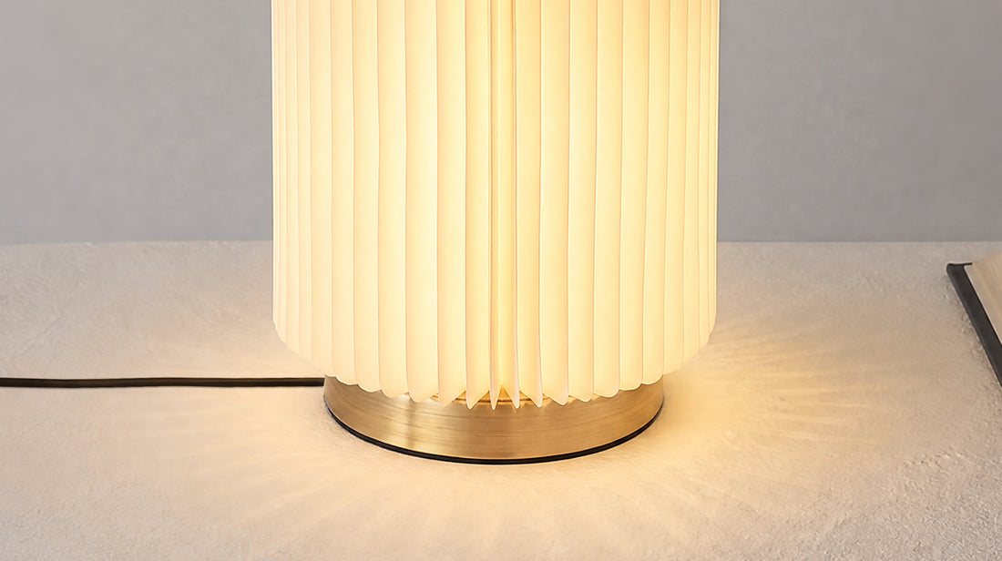 Detailed shot of the artamore pleated paper lamp, showcasing the layered accordion shade that resembles natural bamboo joints and creates a unique light diffusion.