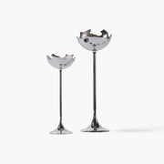 Set of two sculptural metal eggshell candle holders in the moonlight silver finish, showcasing their elegant stems and fluid lines