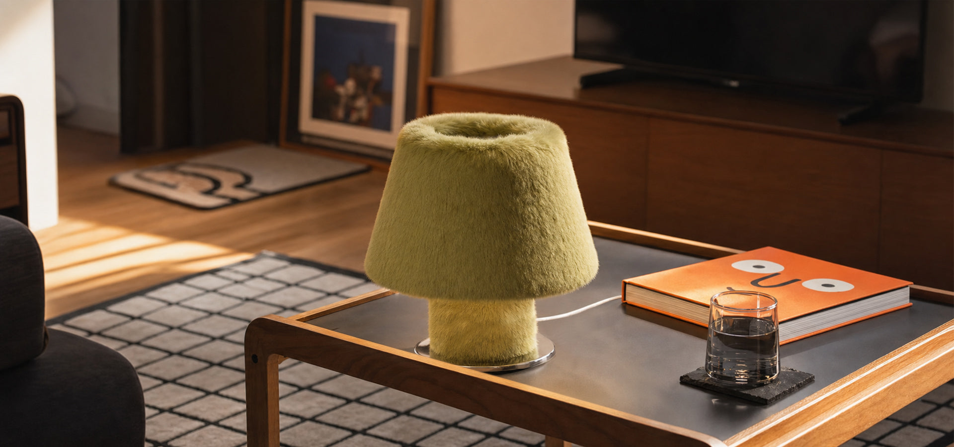 Green furry mushroom table lamp on a wooden coffee table in a warm modern living room.