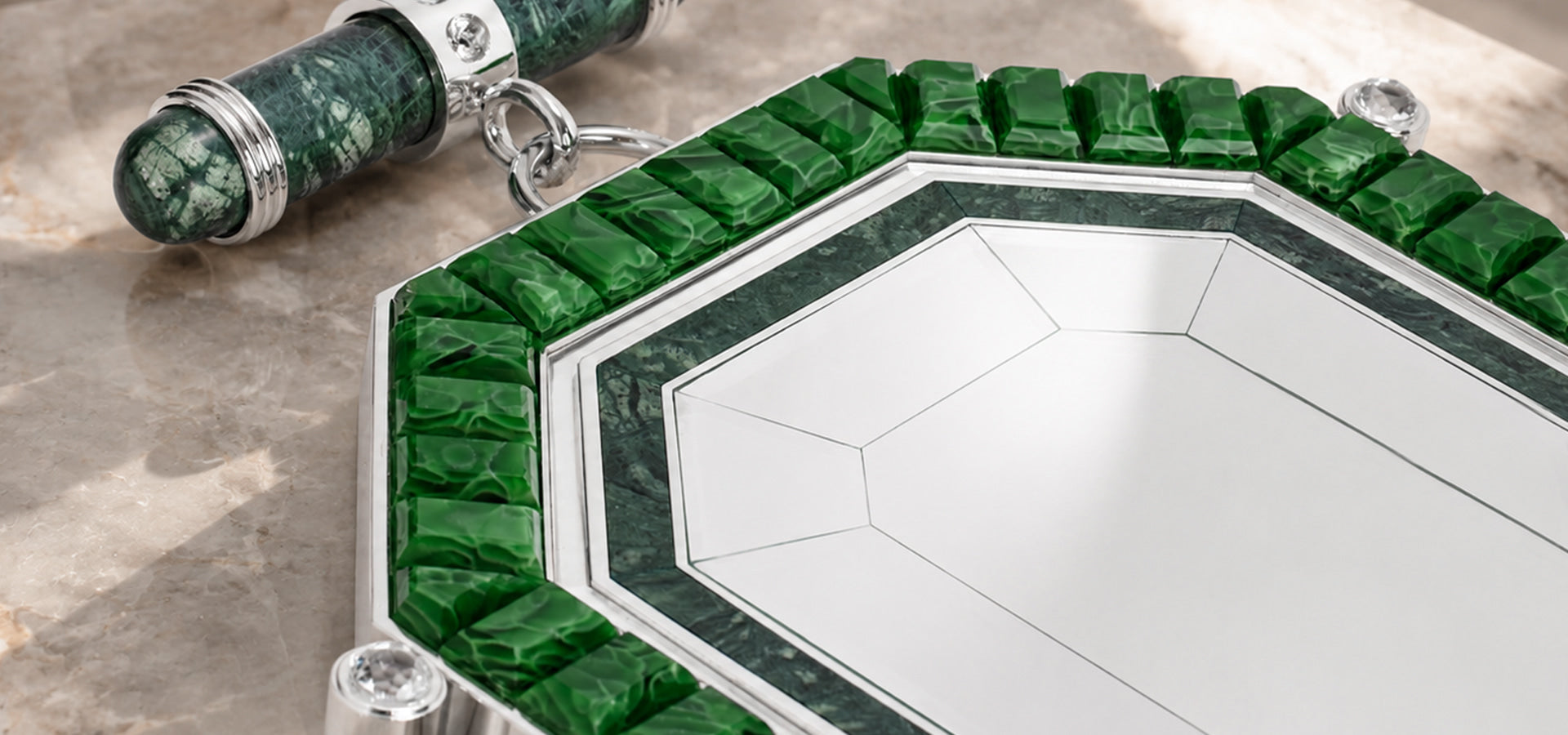 Green recycled glass decorative mirror with polished metal details displayed on a marble surface.