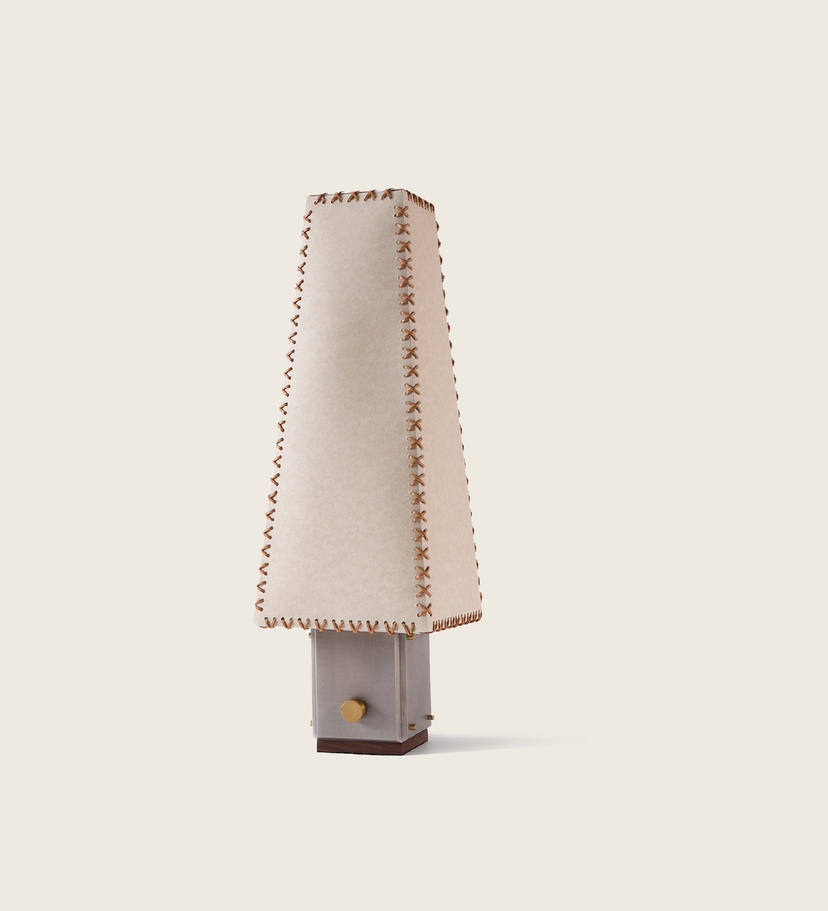 A full view of the artamore parchment table lamp illuminating a warm organic space, highlighting its vintage design inspired by traditional unsent letters.