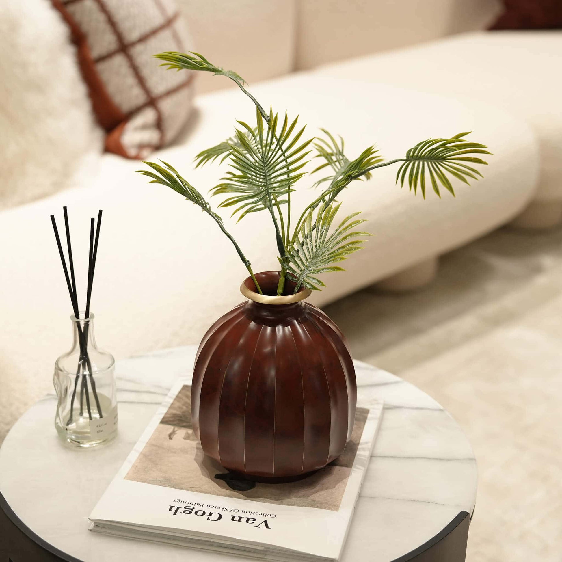 Close-up of the artisanal thermal coloration and organic lustrous glow on the heavy brass vase.