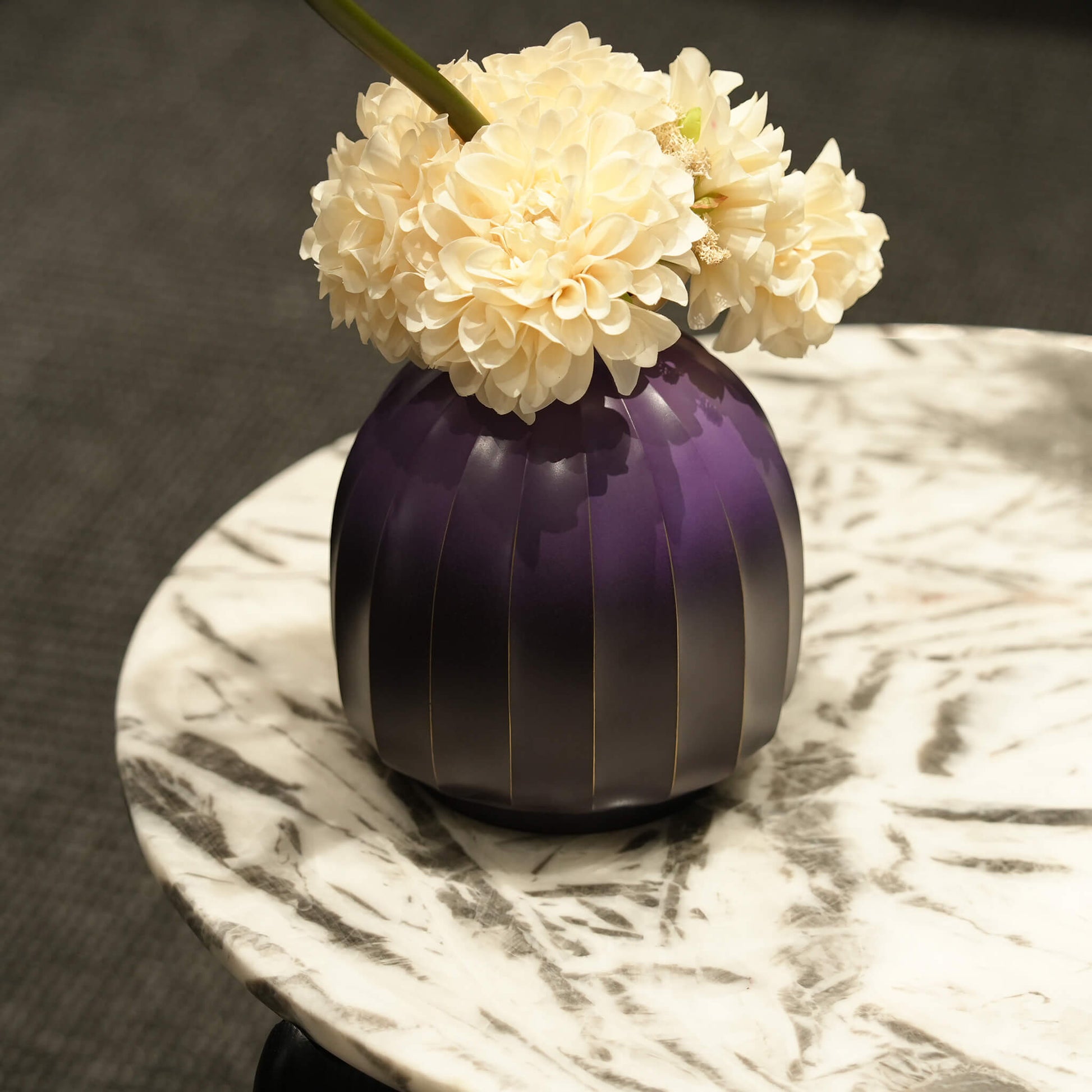 Solid brass lantern vase styled in a warm modern organic minimalist living room setting.