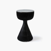 Elegant black kraft paper side table featuring an hourglass silhouette and tempered glass top.