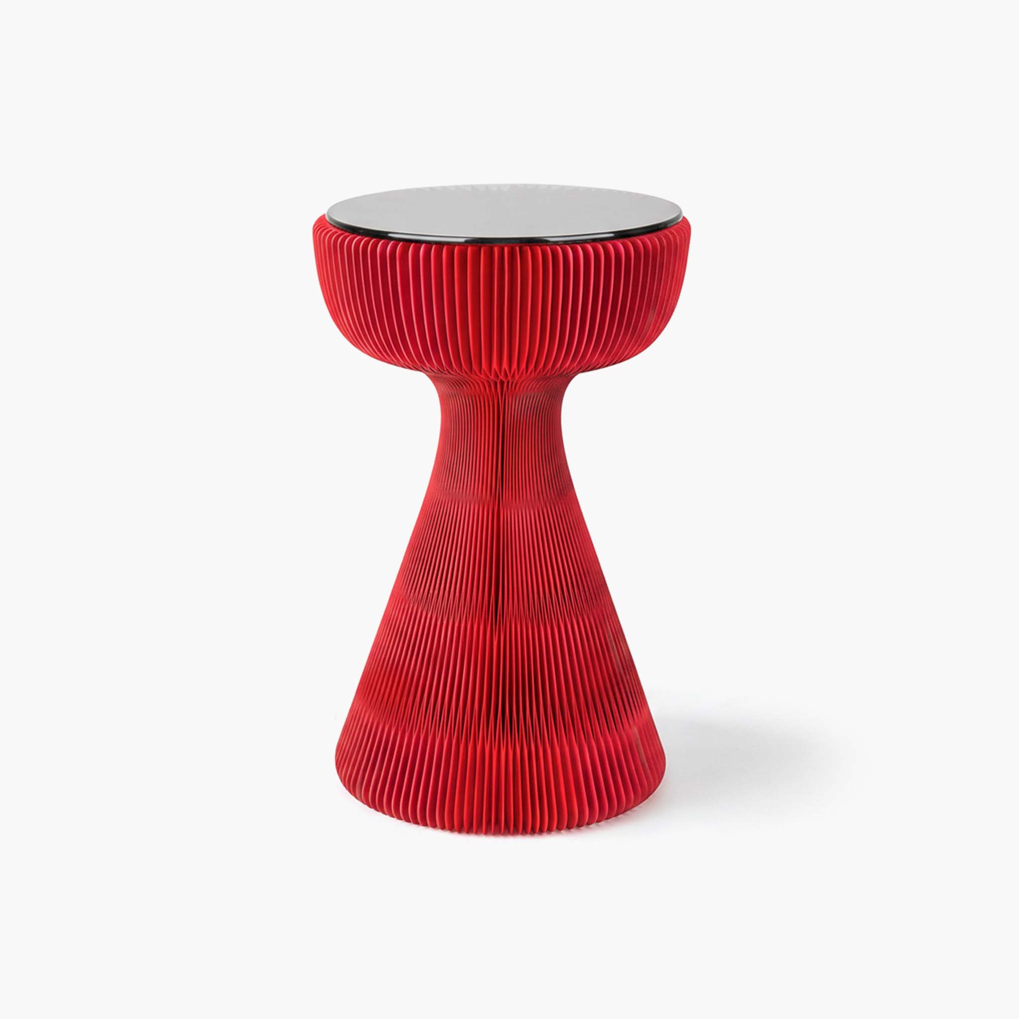 Striking red kraft paper accent table bringing quiet luxury and functional art to curated spaces.