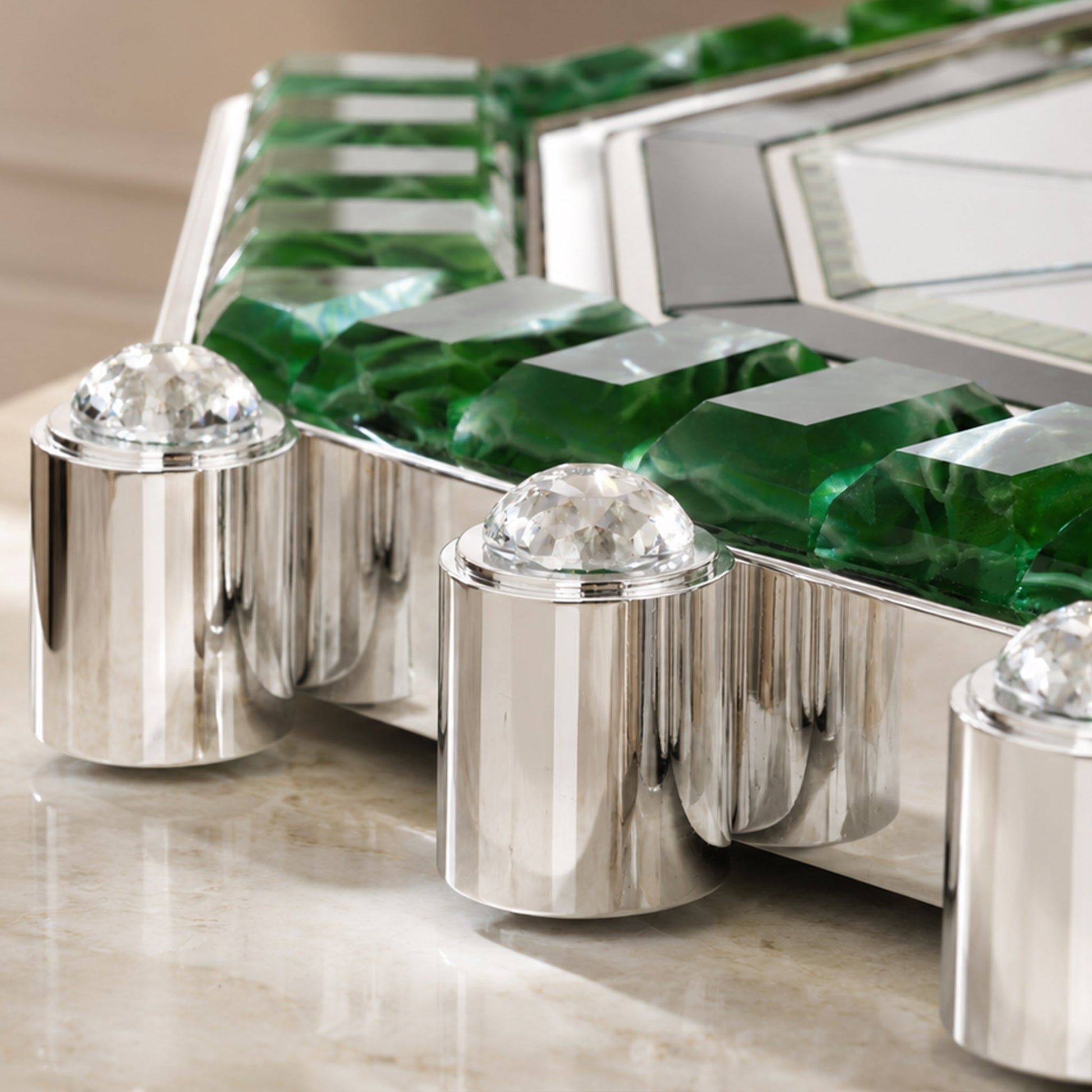 Luxury green Art Deco mirror detail with crystal hardware and polished chrome finish.