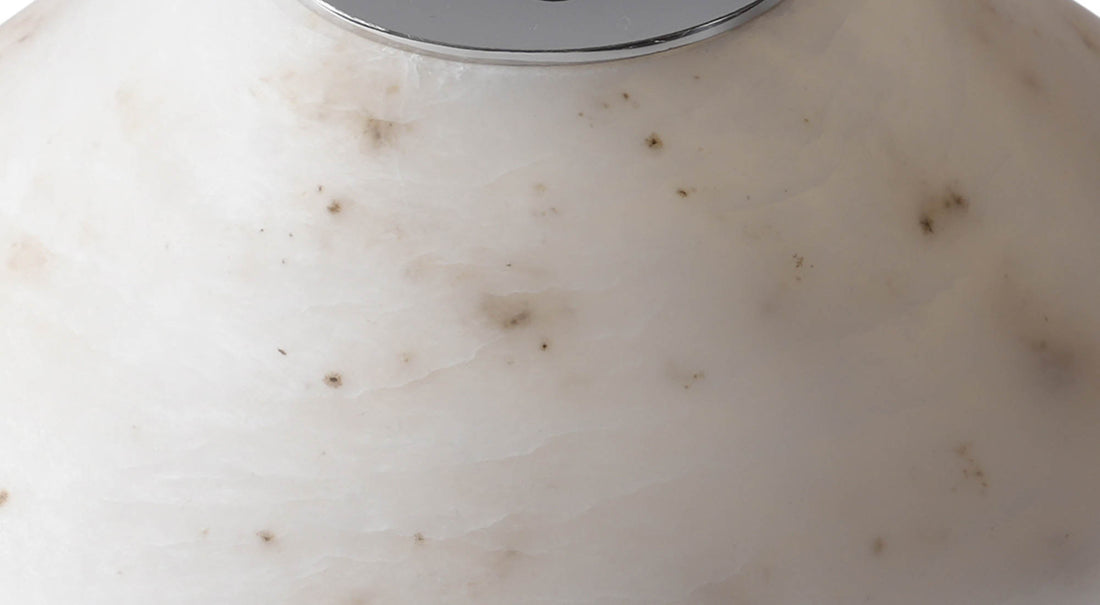 A macro view of the artamore table lamp's premium marble surface, revealing the authentic and unrepeatable natural veining of the stone.