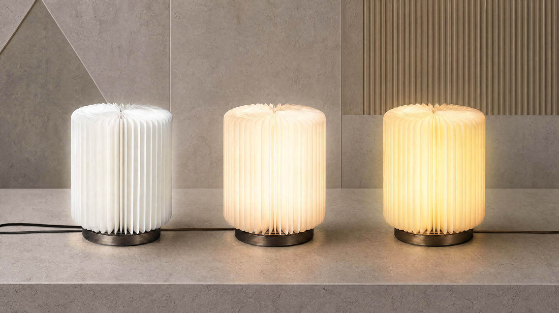 The artamore minimalist bedside lamp placed on a small side table, demonstrating its three adjustable color temperatures to perfectly match any spatial mood.