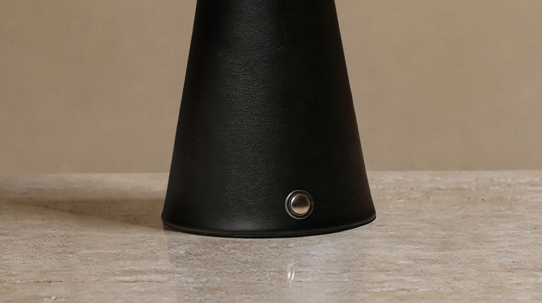 The sturdy black metal body of the artamore minimalist night light, demonstrating a calm, sophisticated design that perfectly complements the marble shade.