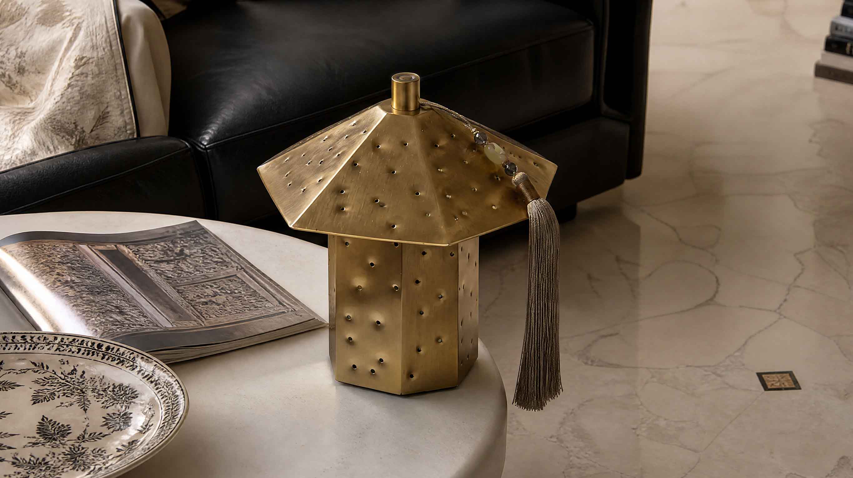 The artamore oriental art night light in a warm minimalist setting, showcasing its unique hammered hole craftsmanship inspired by the infinite possibilities of the universe.