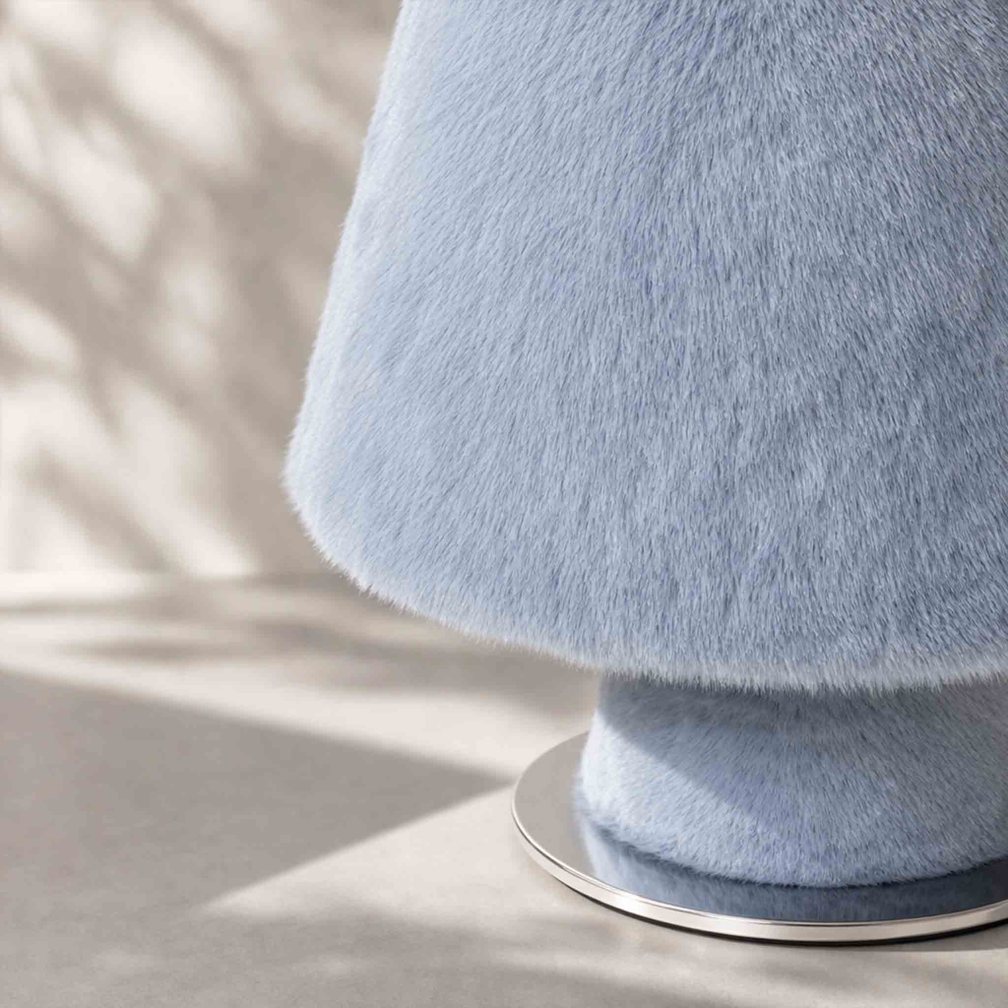 Minimalist plush faux fur table lamp showcasing its classic silhouette and tactile texture.