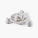 Sculptural ceramic candle holder nested perfectly inside a matching beige textured tray