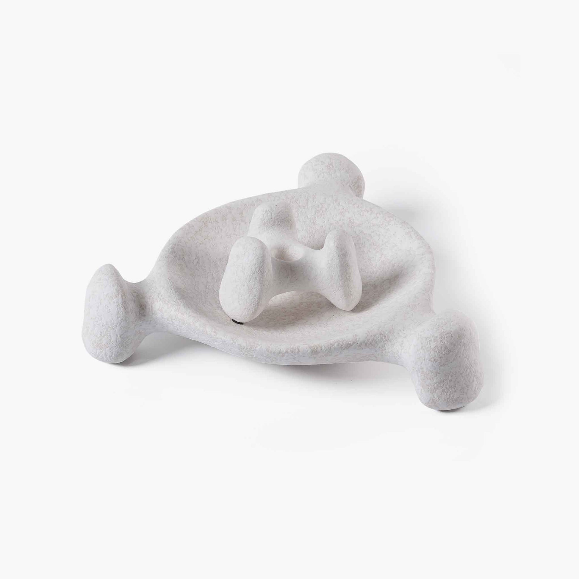Sculptural ceramic candle holder nested perfectly inside a matching beige textured tray