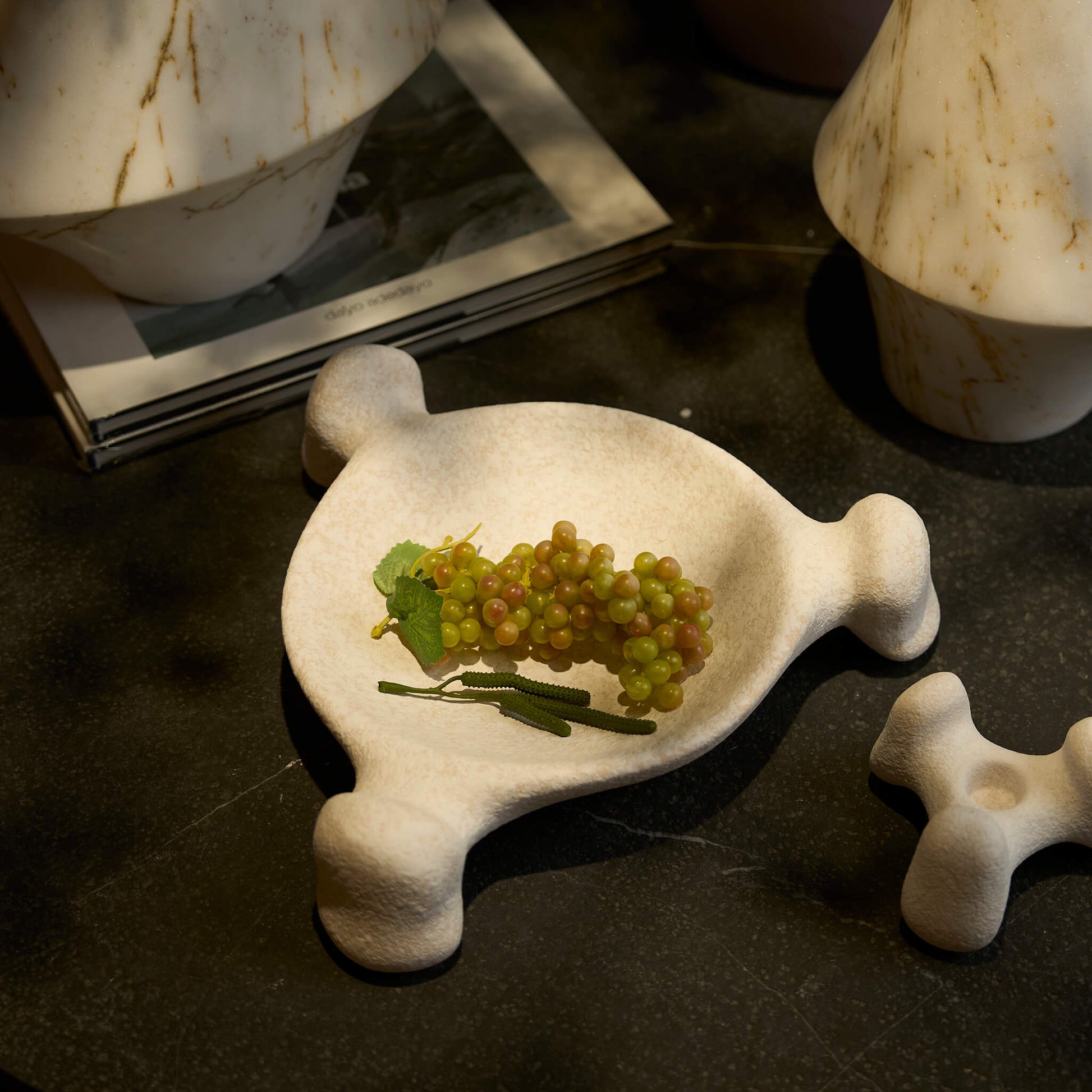 Top down view of the beige ceramic tray highlighting its undulating natural curves