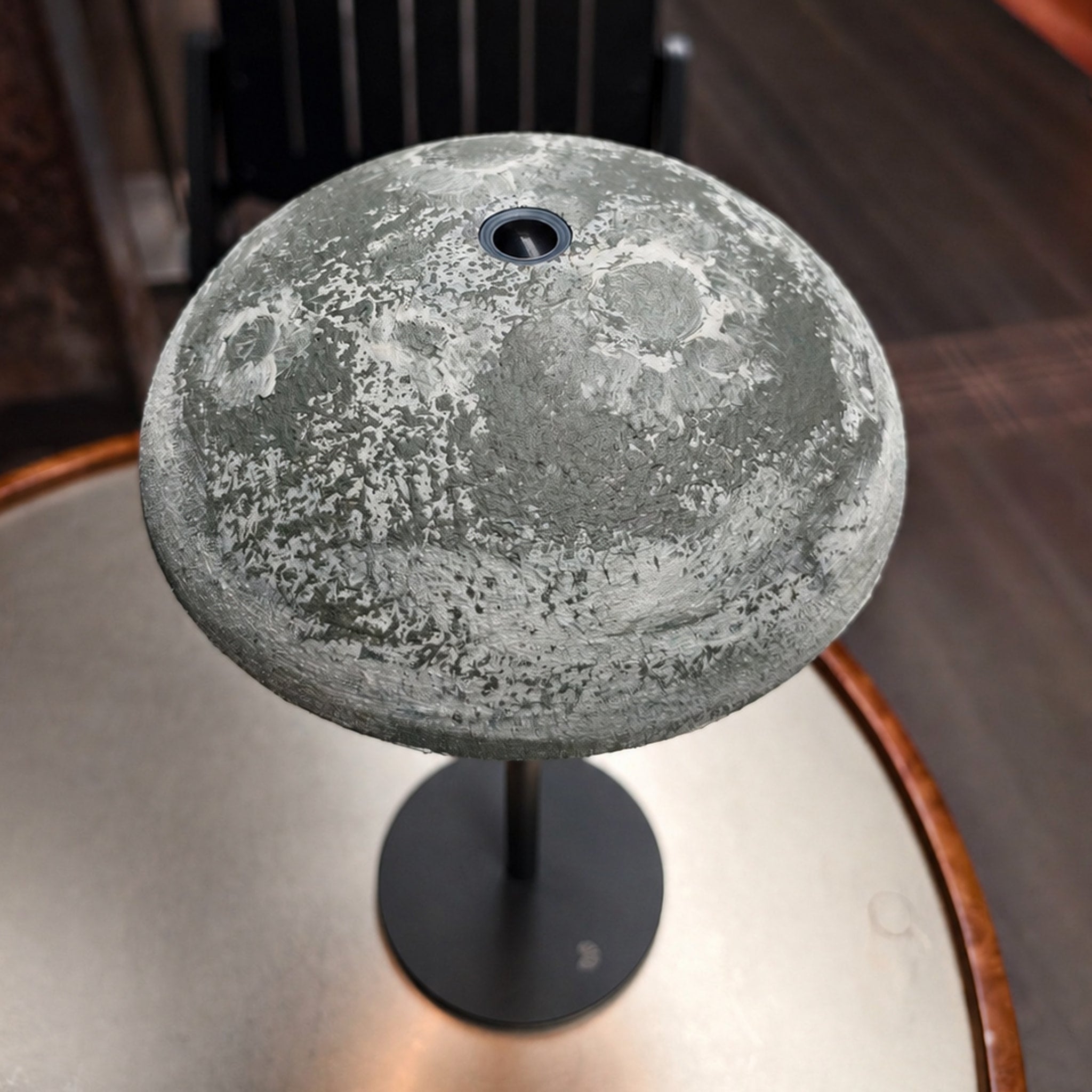 Close-up of a gray hand-finished Relax-W lamp shade with a textured DIY surface and black base.