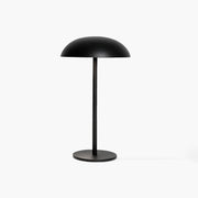 Sleek black industrial-style desk lamp featuring a cool aluminum head and handcrafted micro-cement foundation.