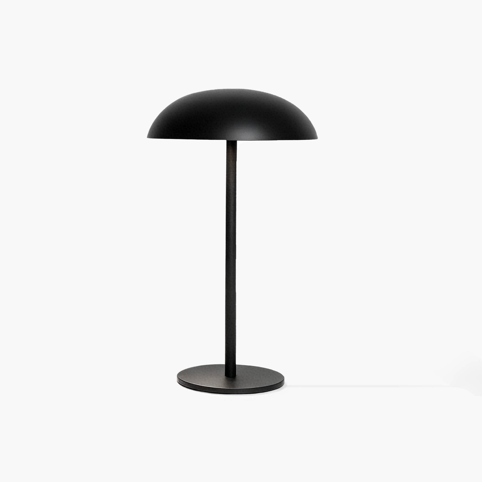 Sleek black industrial-style desk lamp featuring a cool aluminum head and handcrafted micro-cement foundation.