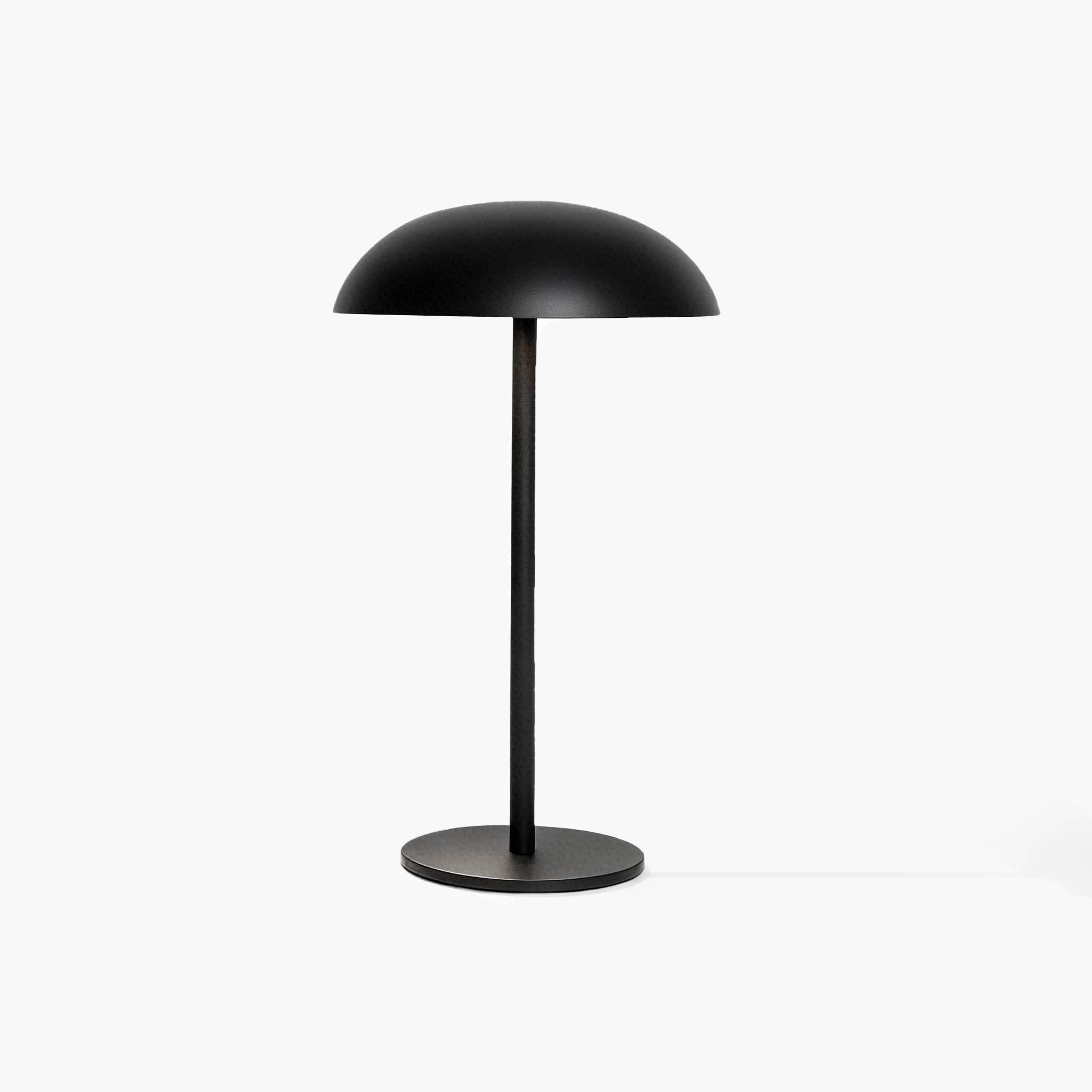 Sleek black industrial-style desk lamp featuring a cool aluminum head and handcrafted micro-cement foundation.