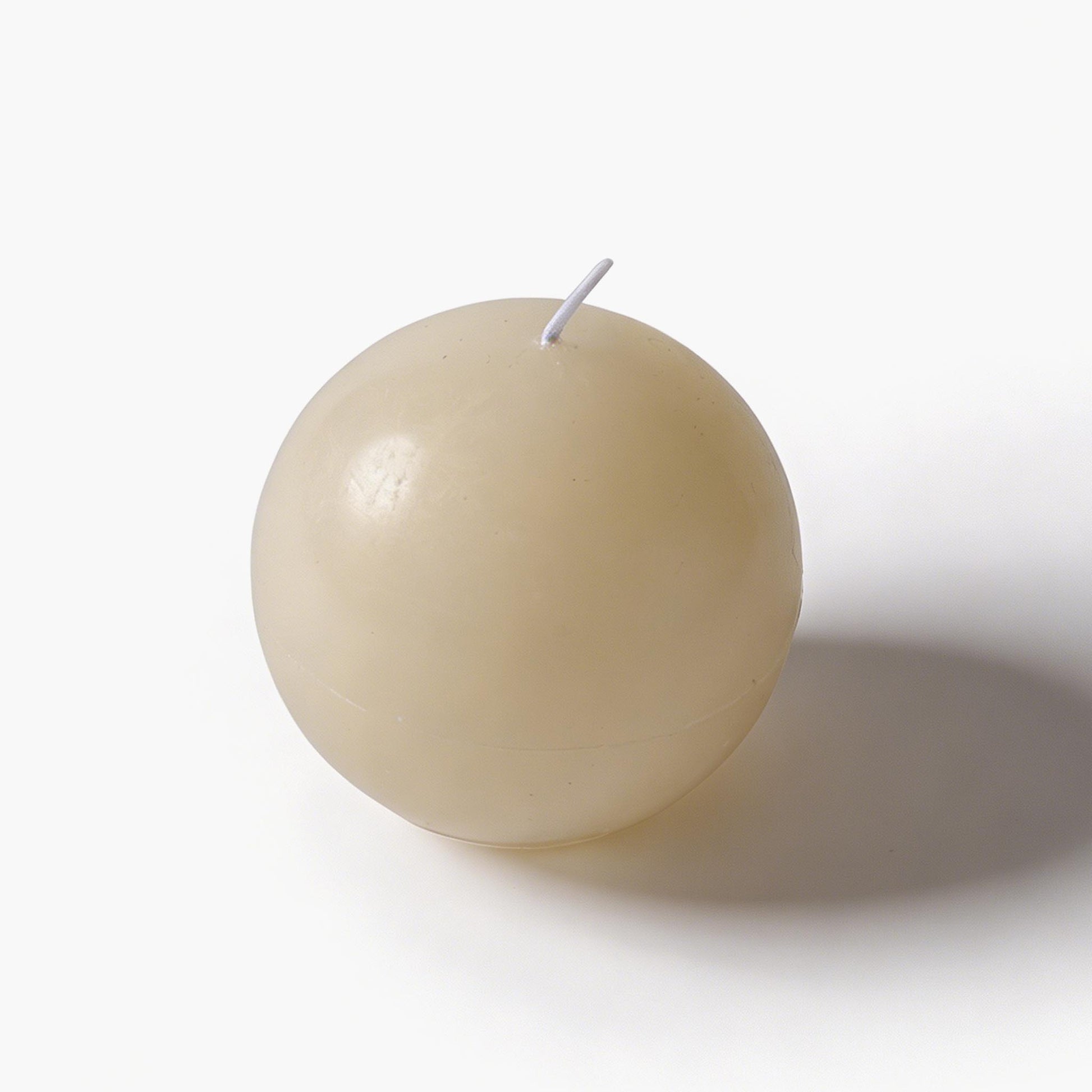 Minimalist white sculptural knot decor resting on dark wood, an essential piece for quiet luxury styling.