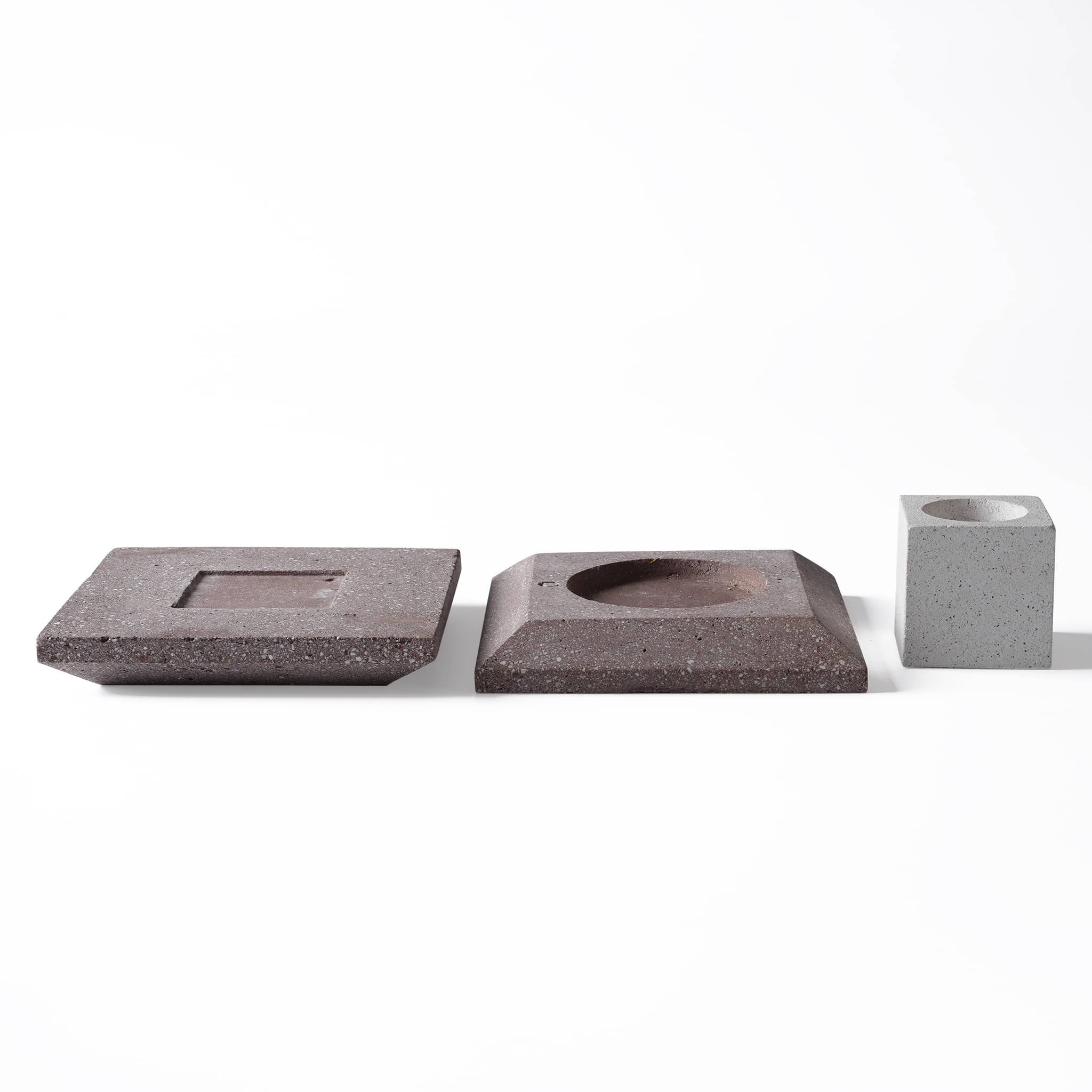 The sustainable ceramic diffuser disassembled into its modular square base and cubic top parts, highlighting its functional design