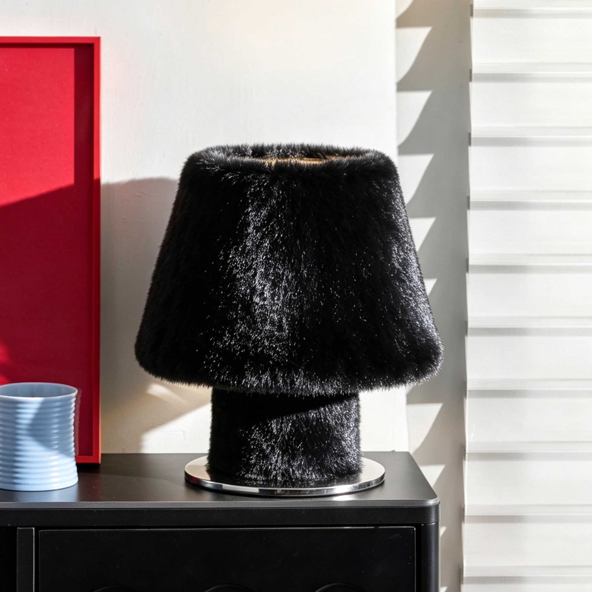 Sculptural black faux fur bedside lamp with an organic modern aesthetic