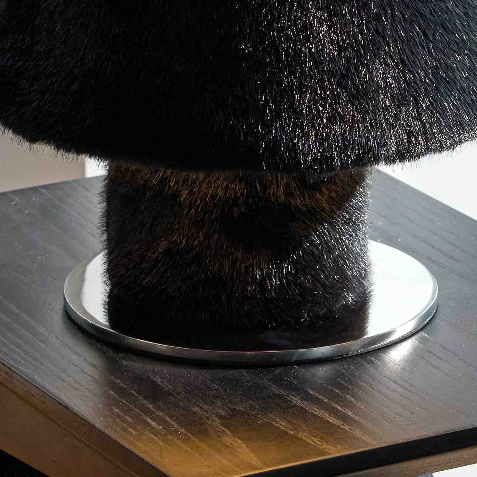 Detail of the plush black base and soft light diffusing from the lamp