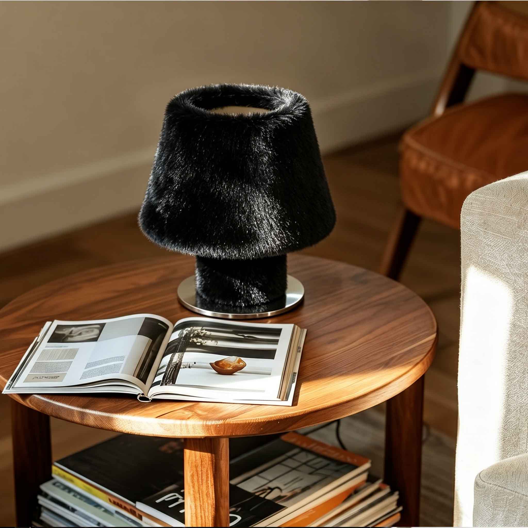 Black luxury faux fur table lamp illuminating a modern wooden coffee table