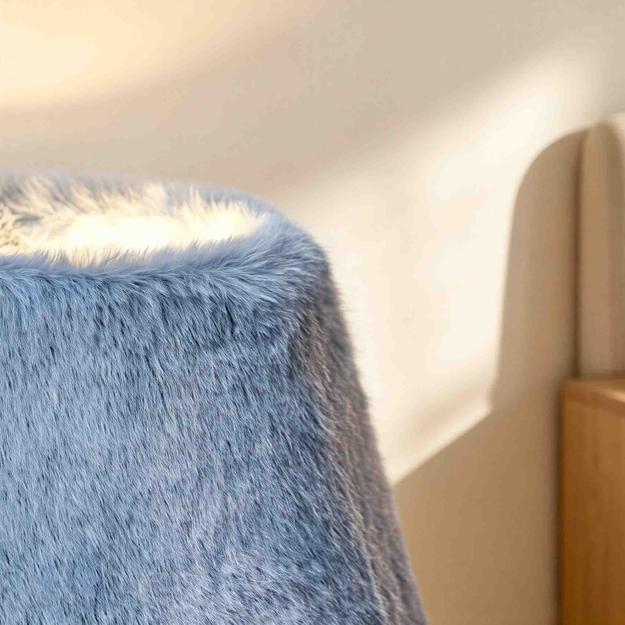 Tactile blue faux fur material glowing under warm modern illumination