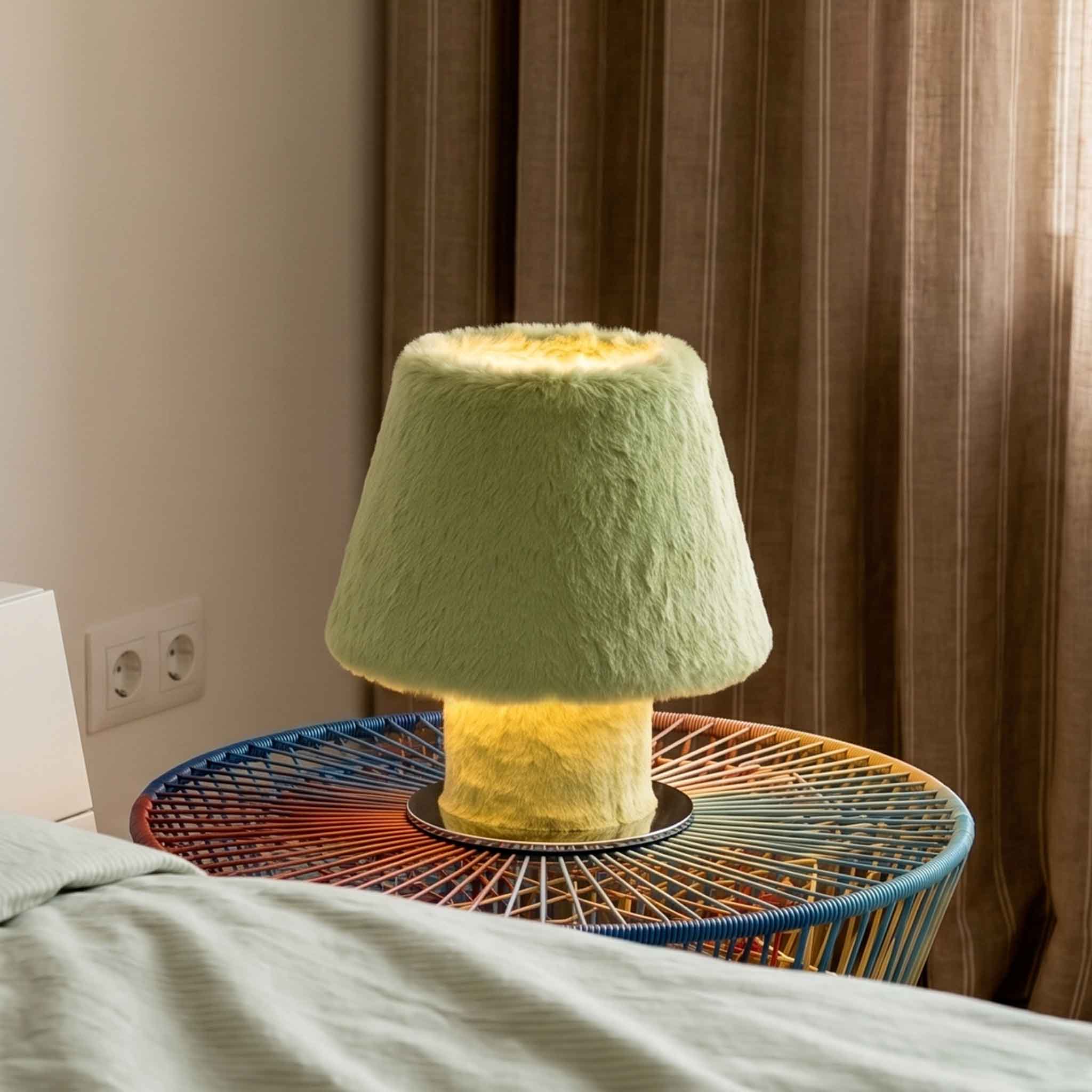 Green luxury faux fur table lamp illuminating a modern woven side table