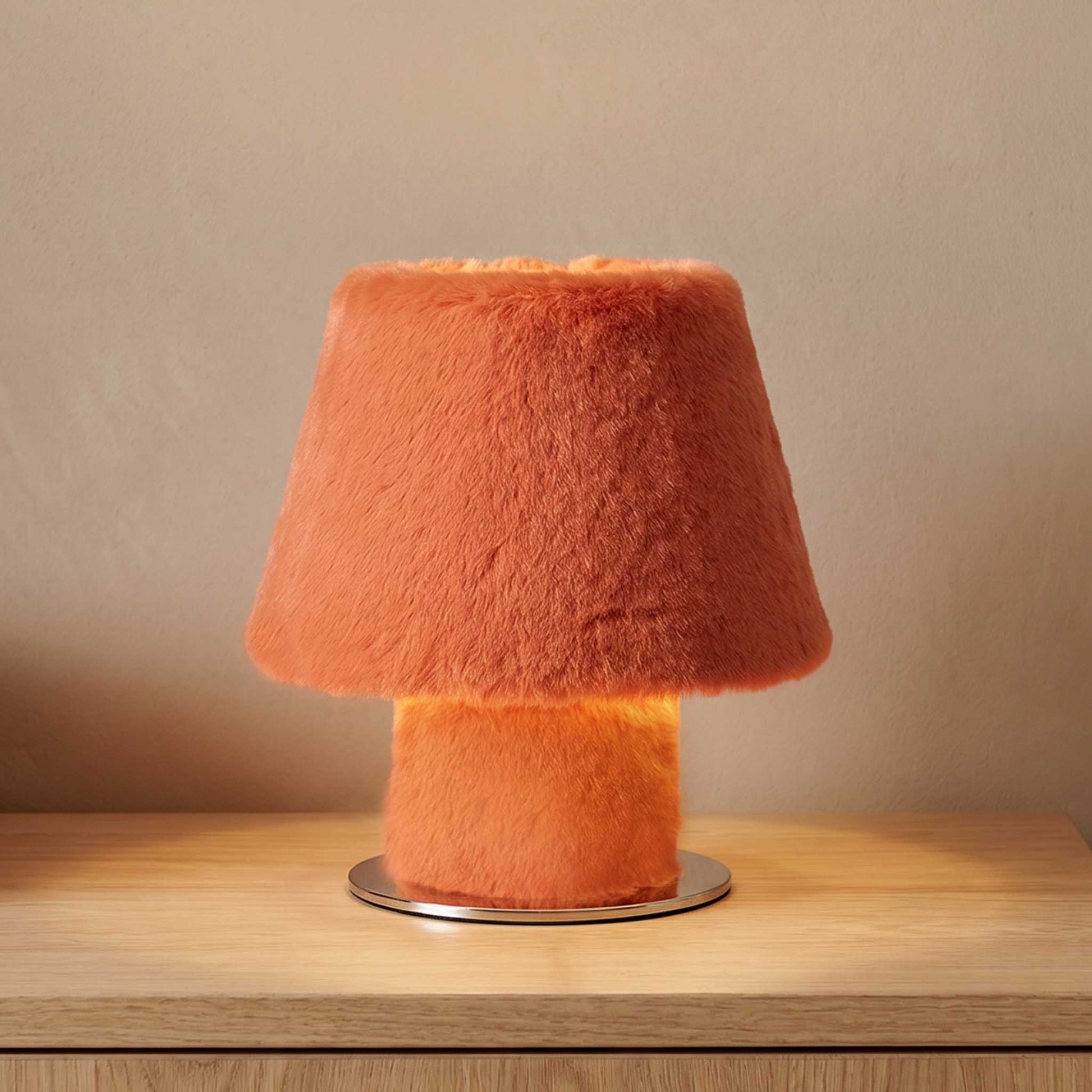 Illuminated fluffy table lamp radiating warm ambient light