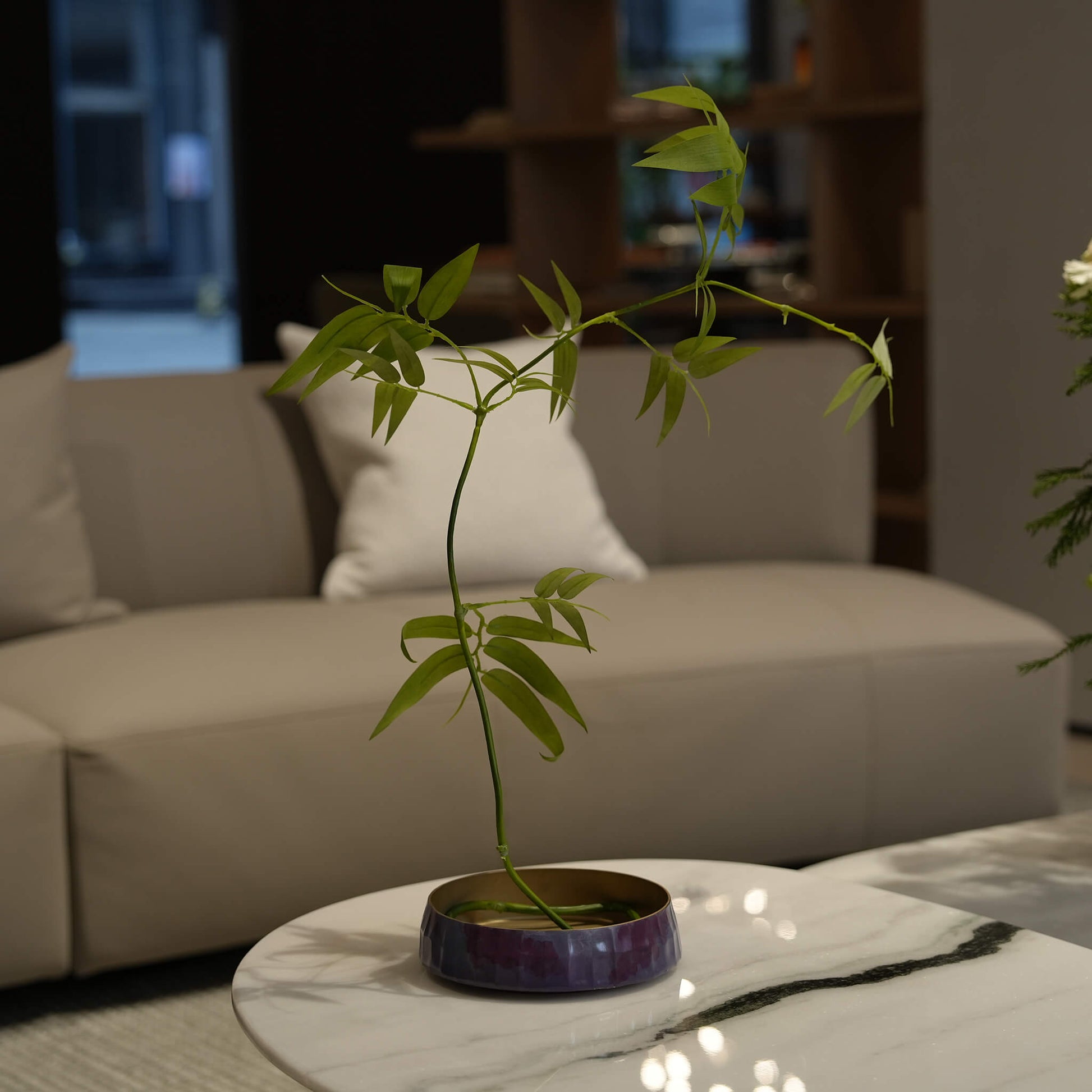 The Wish Zen Ikebana Vessel styled on a marble coffee table , allowing the creation of multidimensional scenes in a modern living space