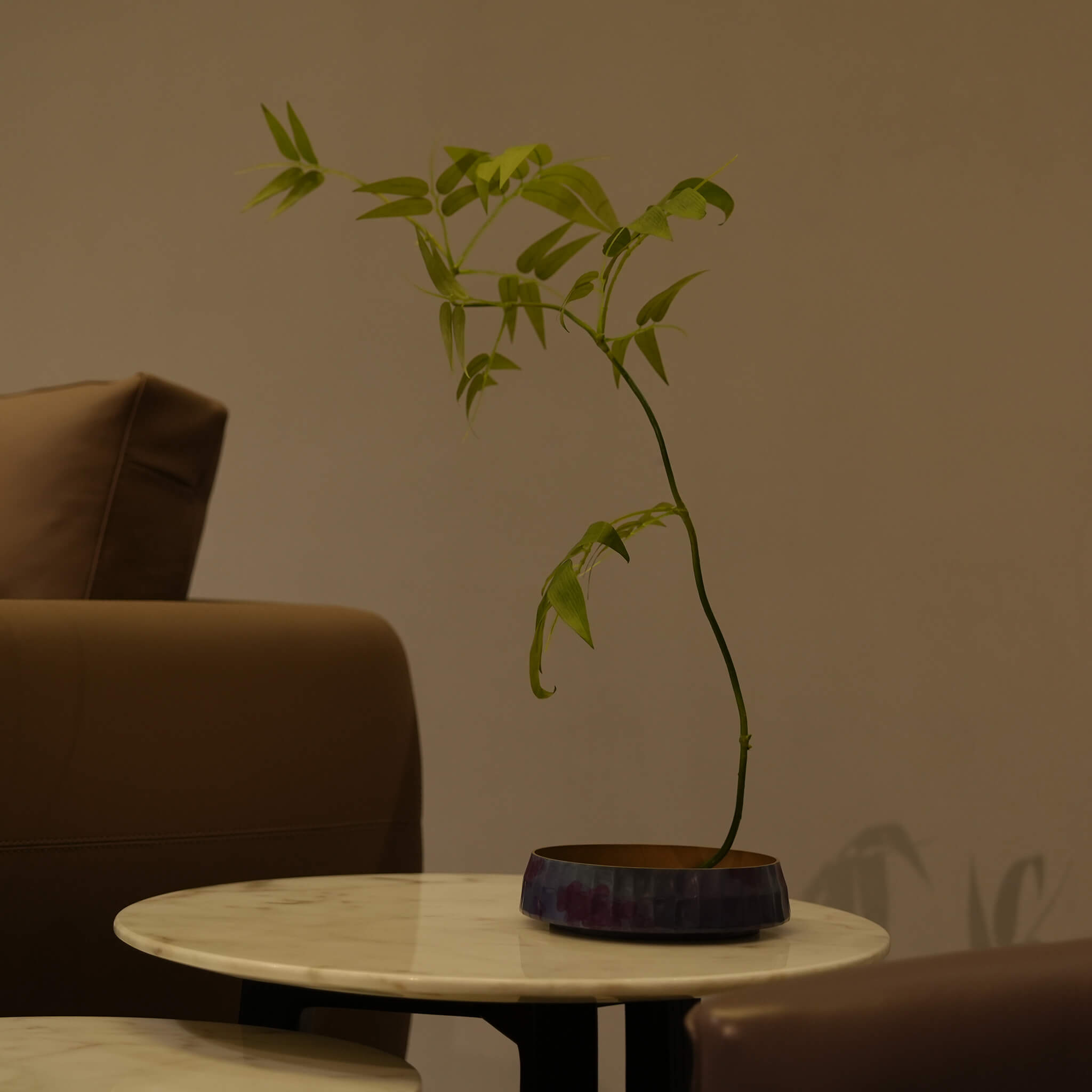 Elegant Ikebana composition using the purple brass vessel , merging minimalist European aesthetics with modern botanical design