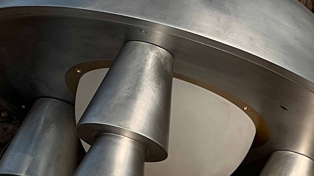 A macro view of the artamore table lamp's base, highlighting the intuitive and elegantly hidden touch control switch seamlessly integrated into the metal leg.