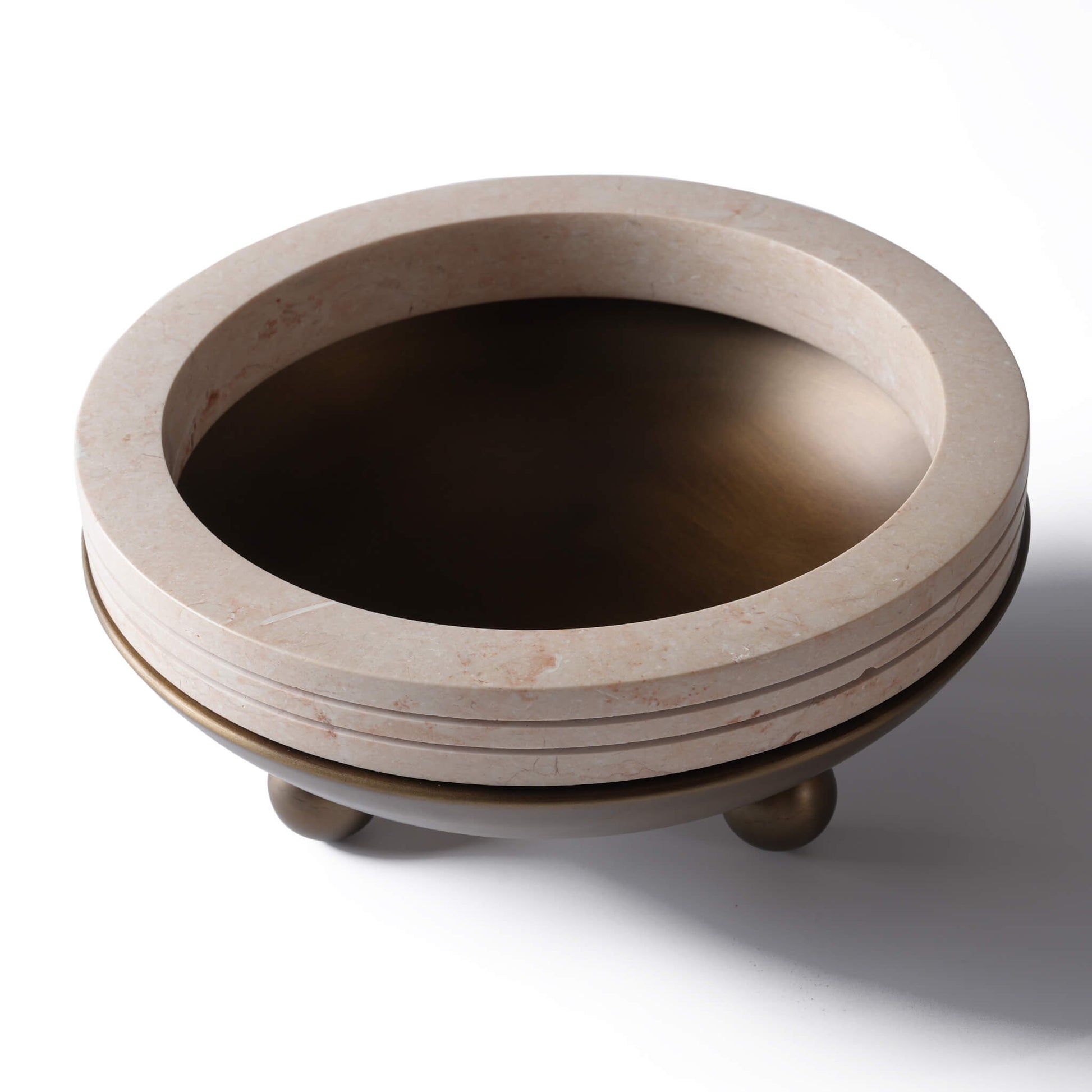 Angled view showcasing the deep antique bronze basin and natural veining of the yellow travertine rings