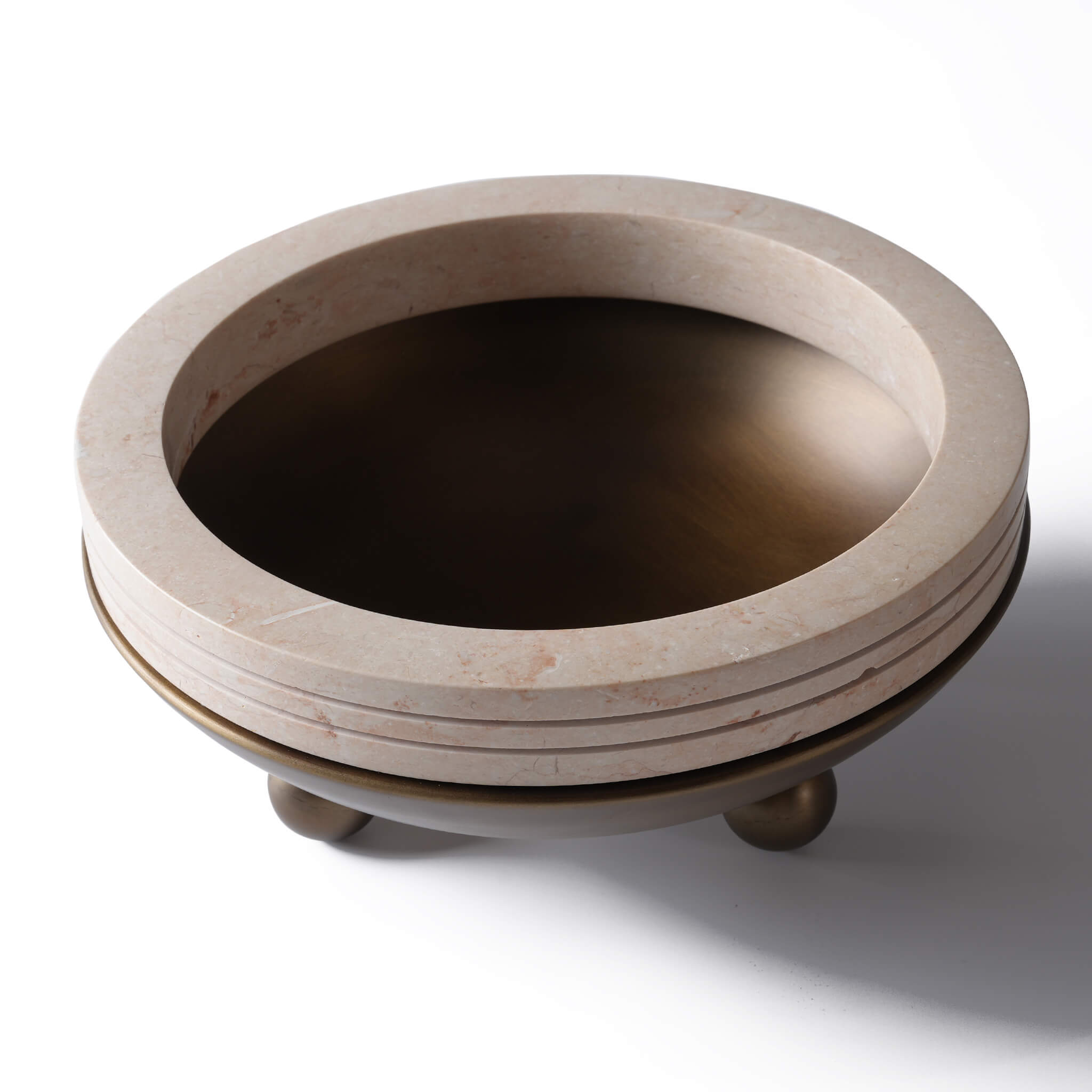 Angled view showcasing the deep antique bronze basin and natural veining of the yellow travertine rings