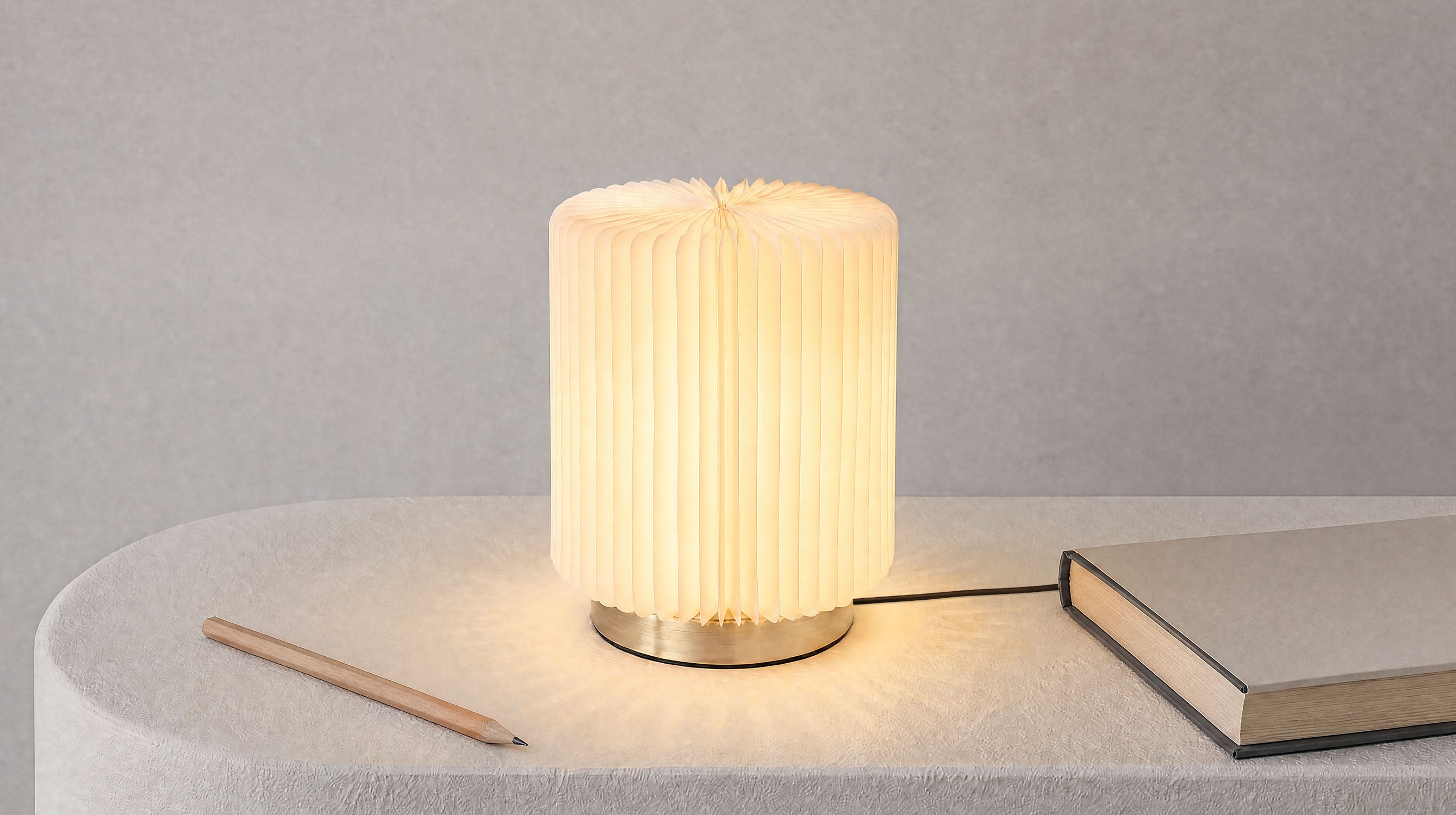 A tranquil lifestyle view of the artamore wabi-sabi table lamp, infusing Eastern aesthetics into a modern home with its soft, diffused bamboo-shadow glow.