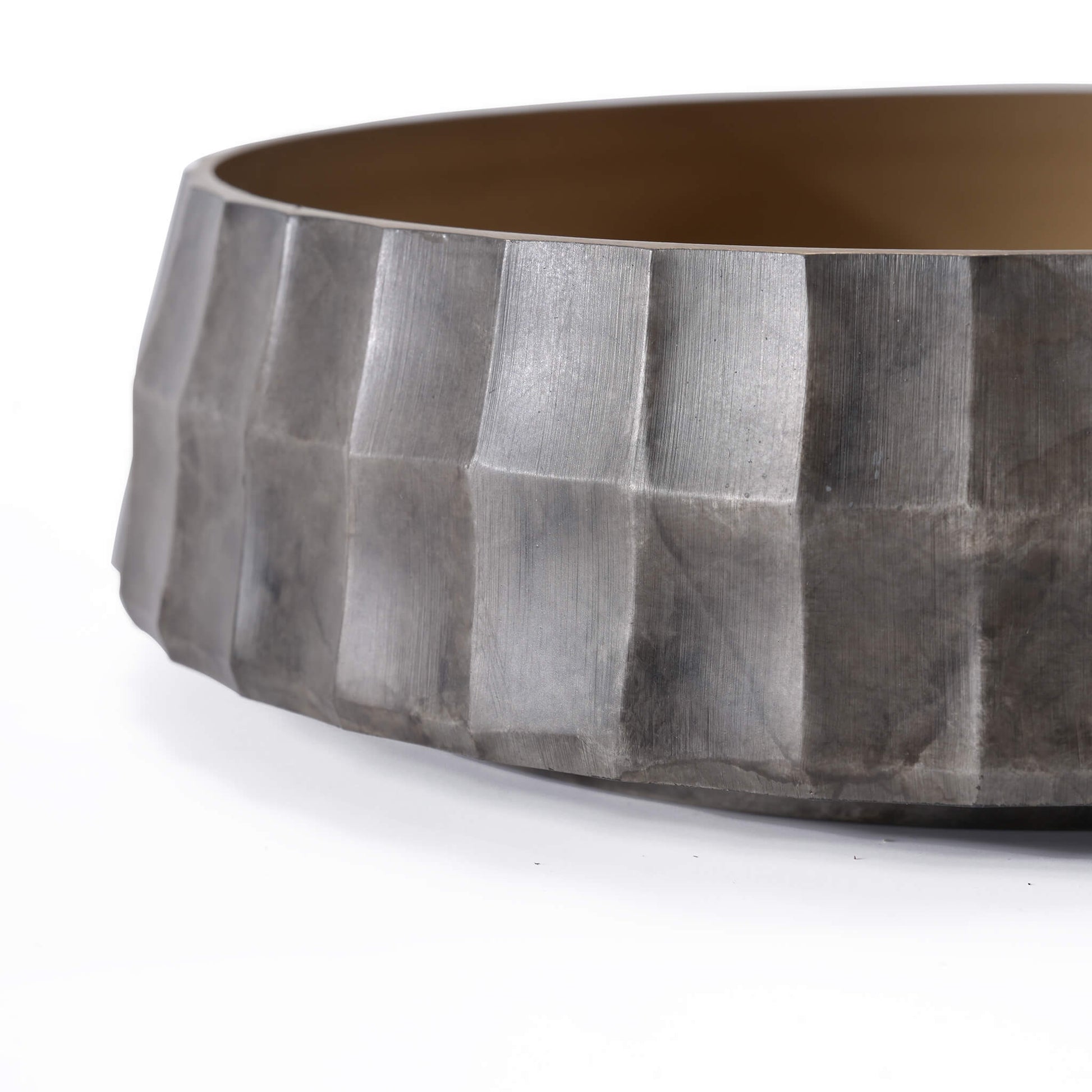 Detail of the handcrafted brass flower bowl featuring a sophisticated square-grid facade